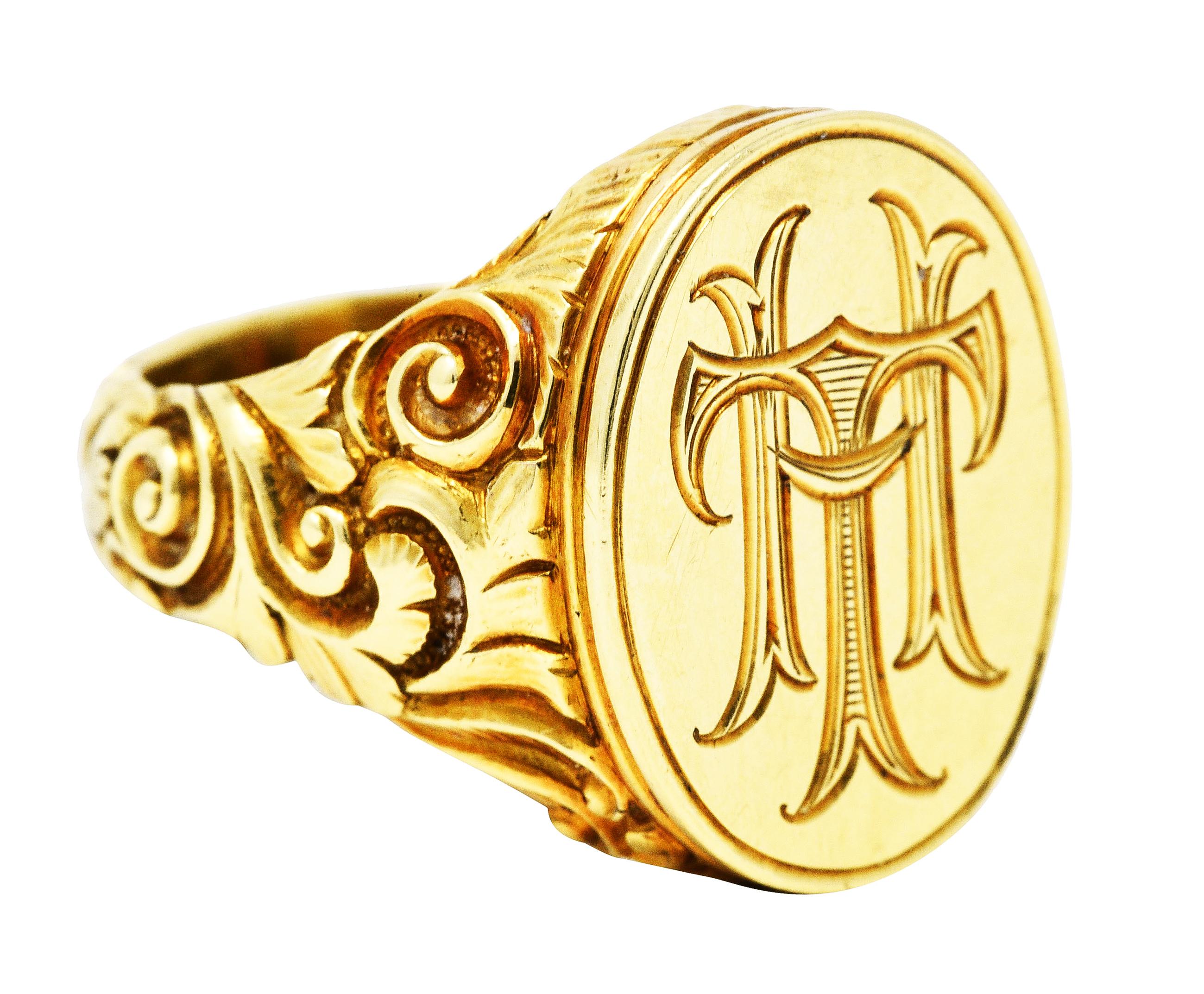 Ring features flat oval signet face with stylized monogram engraving

Featuring deeply grooved scroll motif extending from shoulders down shank

Stamped 585 for 14 karat gold

With maker's mark for Scofield & Co.

Circa: 1905

Ring size: 9 1/2