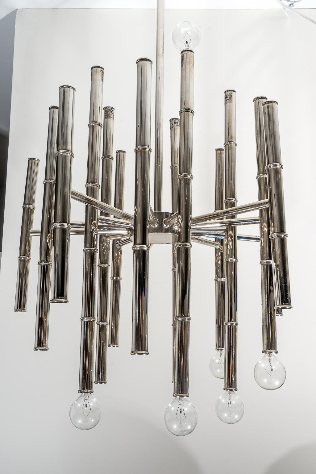 This large scale chandelier is very much in the style of pieces created by Scolari and will make a definite statement with its polished chrome faux bamboo rods. The elongated from makes it perfect for a stairwell.

Note: The main body measures 22