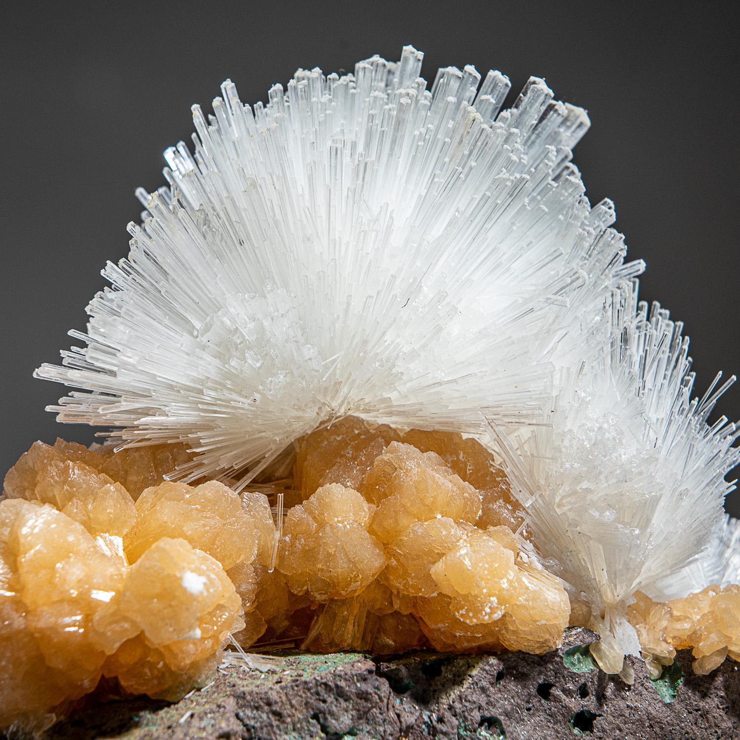 From Nasik District, Maharashtra, India

Large lustrous cluster of an acicular sprays of scolectite crystals on pink stilbite. The scolecite crystals have glassy crystal faces and are mostly translucent to transparent at the terminations.

