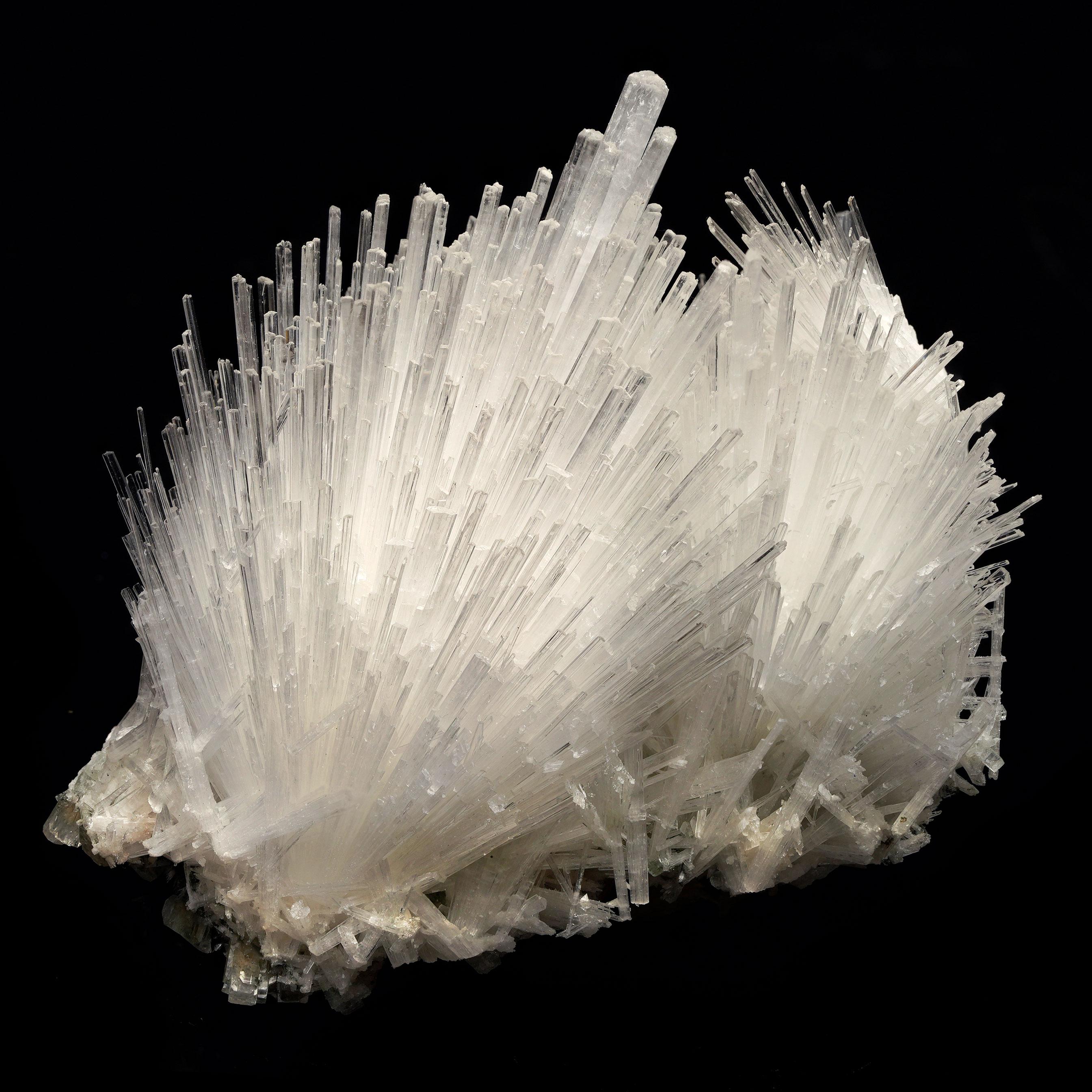 This stunning Scolocite specimen showcases a beautiful, intricate formation that is a true wonder of nature. Its delicate needle-like crystal structures fan out in a mesmerizing pattern, creating a sense of flow and harmony. Sourced from the rich