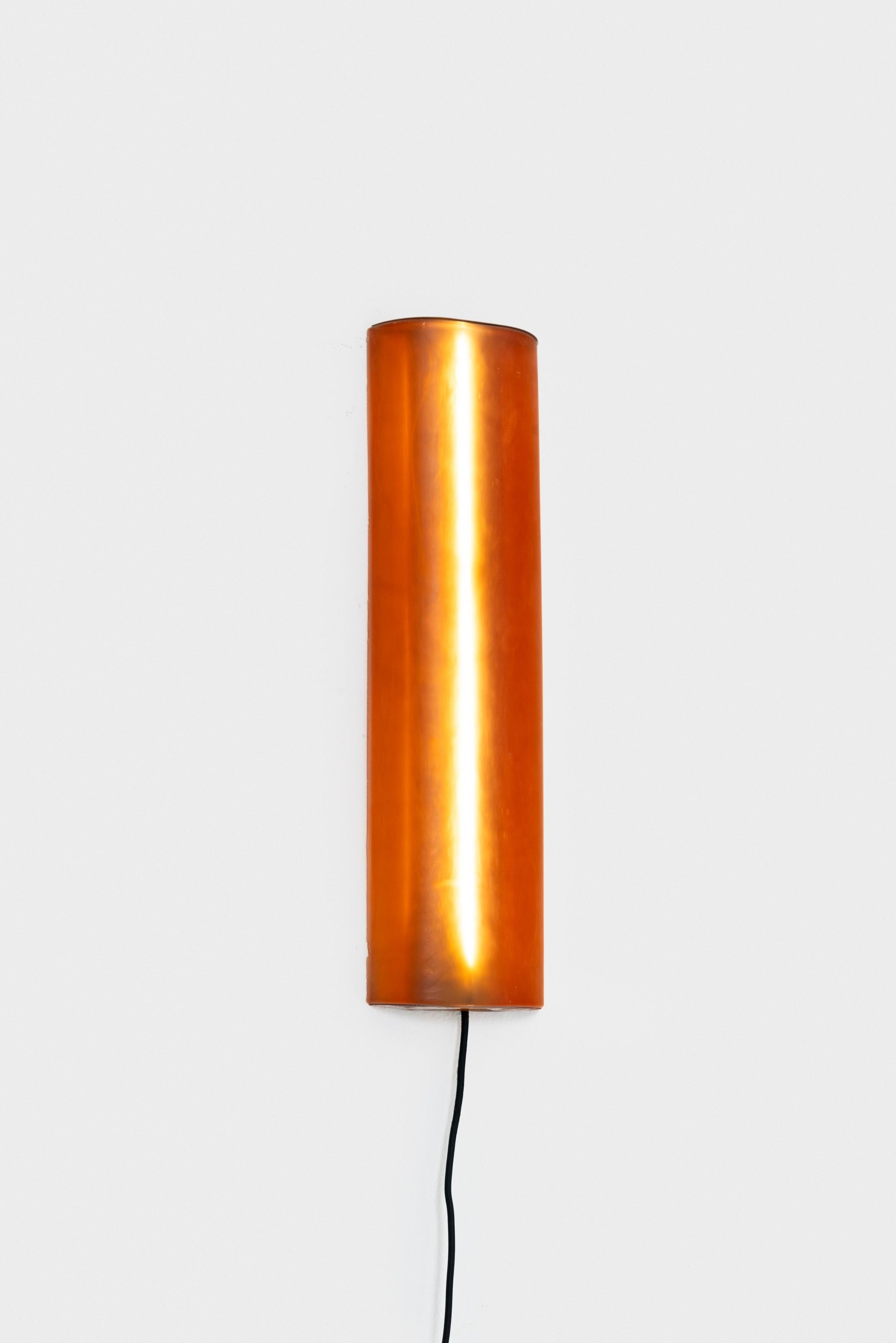 A rubber sconce drawing on Bauhaus rigor and machine-age precision, reframing industrial lighting through a sensual, synthetic lens.

With RUBBERWORKS, Rich Aybar redefines materiality, embracing rubber’s
contradictions—pliable yet strong,