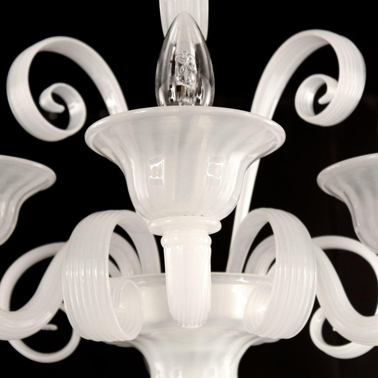 Capriccio sconce 3 lights, white silk  artistic glass, with curly ornamental elements by Multiforme.
Inspired by the Classic Venetian tradition it is characterised by a central column where many blown glass “pastoral” elements are installed. These