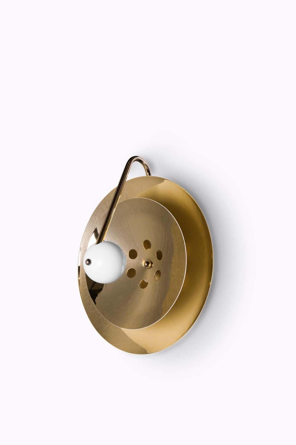 The vintage midcentury lamp has a set of distinctive features which make it a stunning statement piece. It is an indoor wall light handmade in brass, with a center shade made in aluminum and a mesmerizing gold-plated standard finish.
Measures: