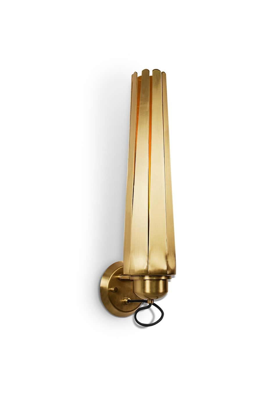 Wall light, a contemporary lighting piece in matte brass. This wall lamp is a versatile piece that will shine like lightning in any modern interior design.
Hammered aged brushed brass with glossy varnish

Measures: Height 25.99 in. (66 cm)
Width