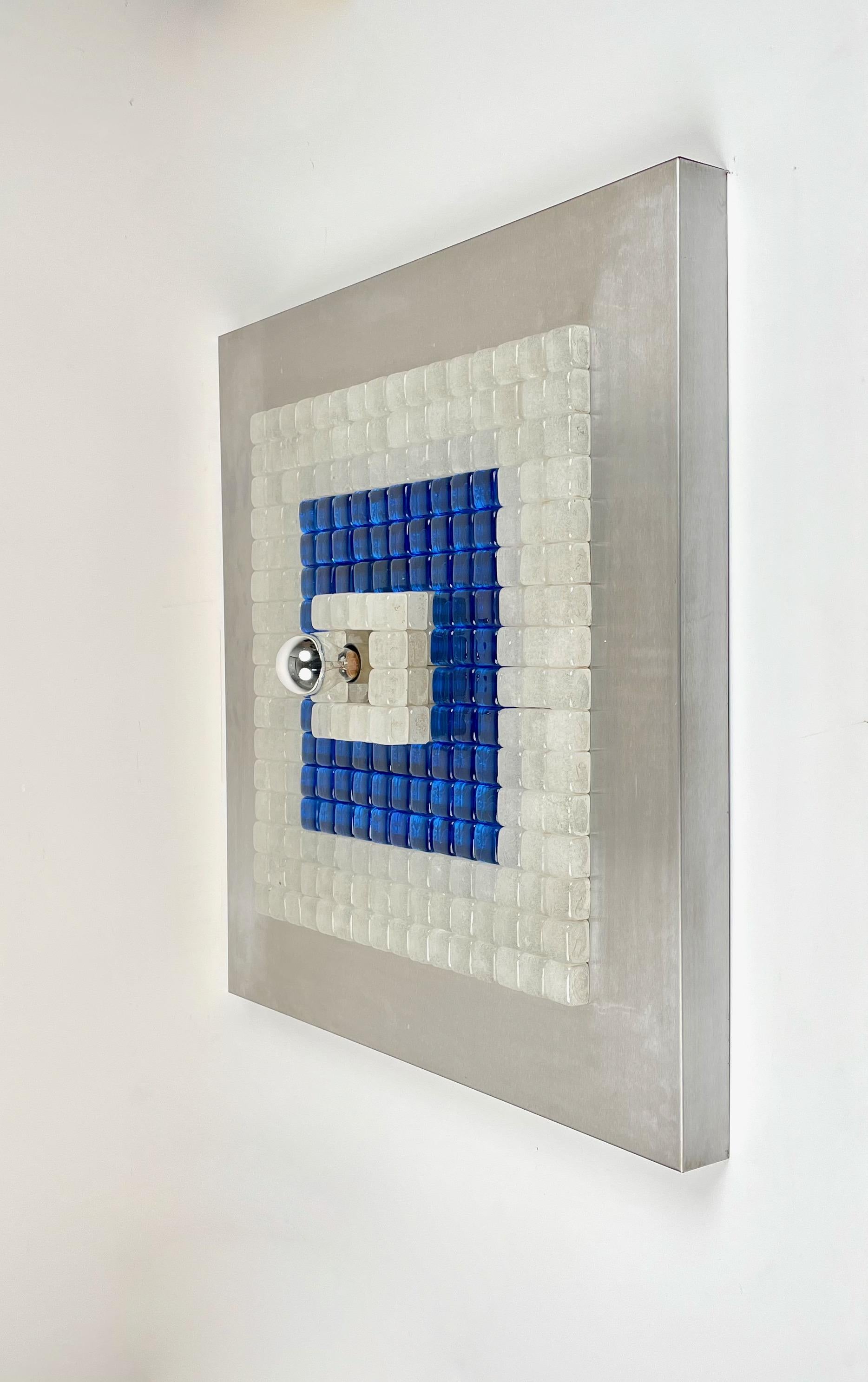 Large squared wall light sconce by Albano Poli for Poliarte made in Italy in the 1970s. 

This astonishing sconce sculpture features a squared base in steel covered by white and blue Murano glass squares with a single light bulb in the centre.
