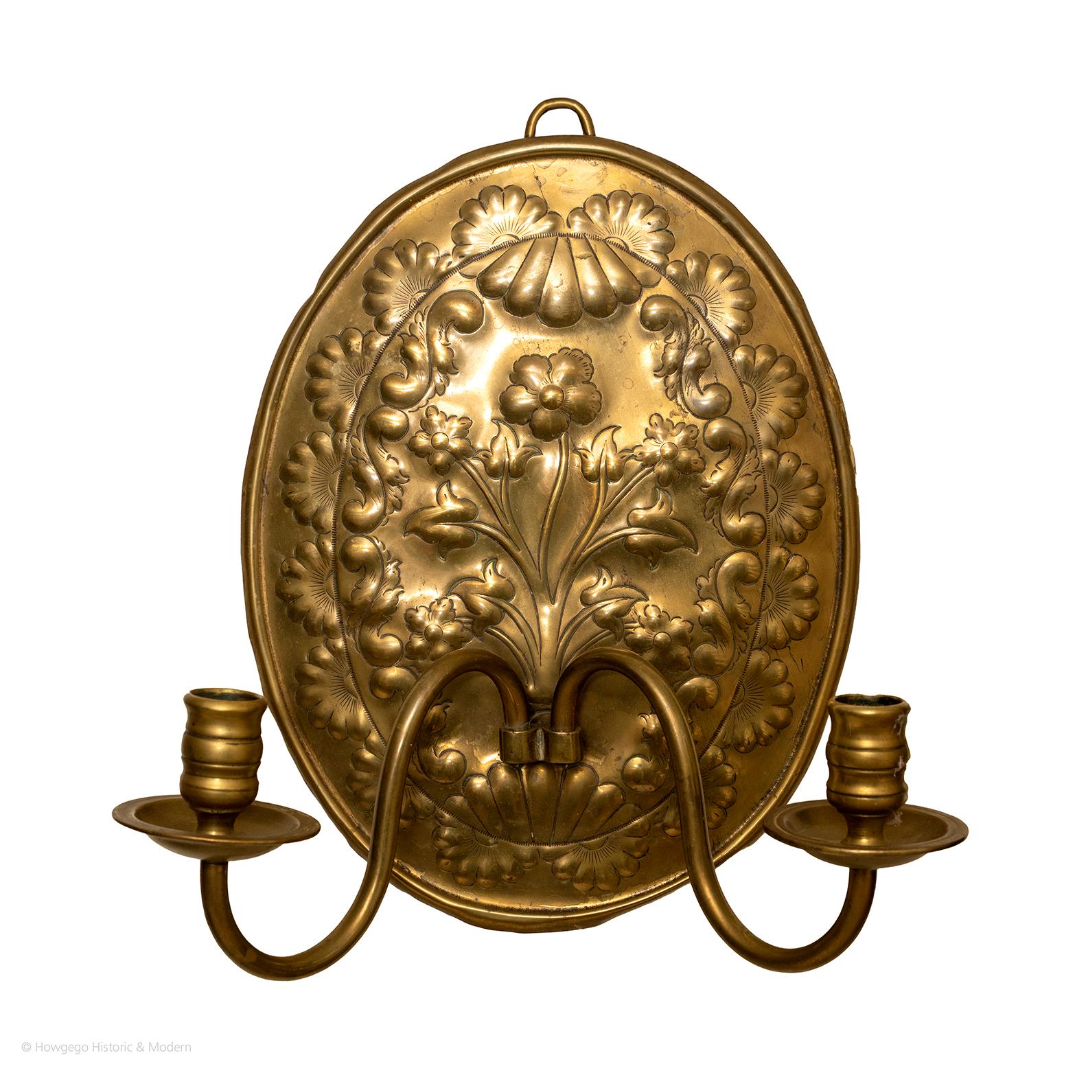 A charming, arts & crafts, oval, brass repousse wall sconce with floral & leaf ornament & two arms
- Naïve charm with a stylised floral arrangements surrounded by scrollwork and an outer border of flowerheads
Blends and sit comfortably in period,