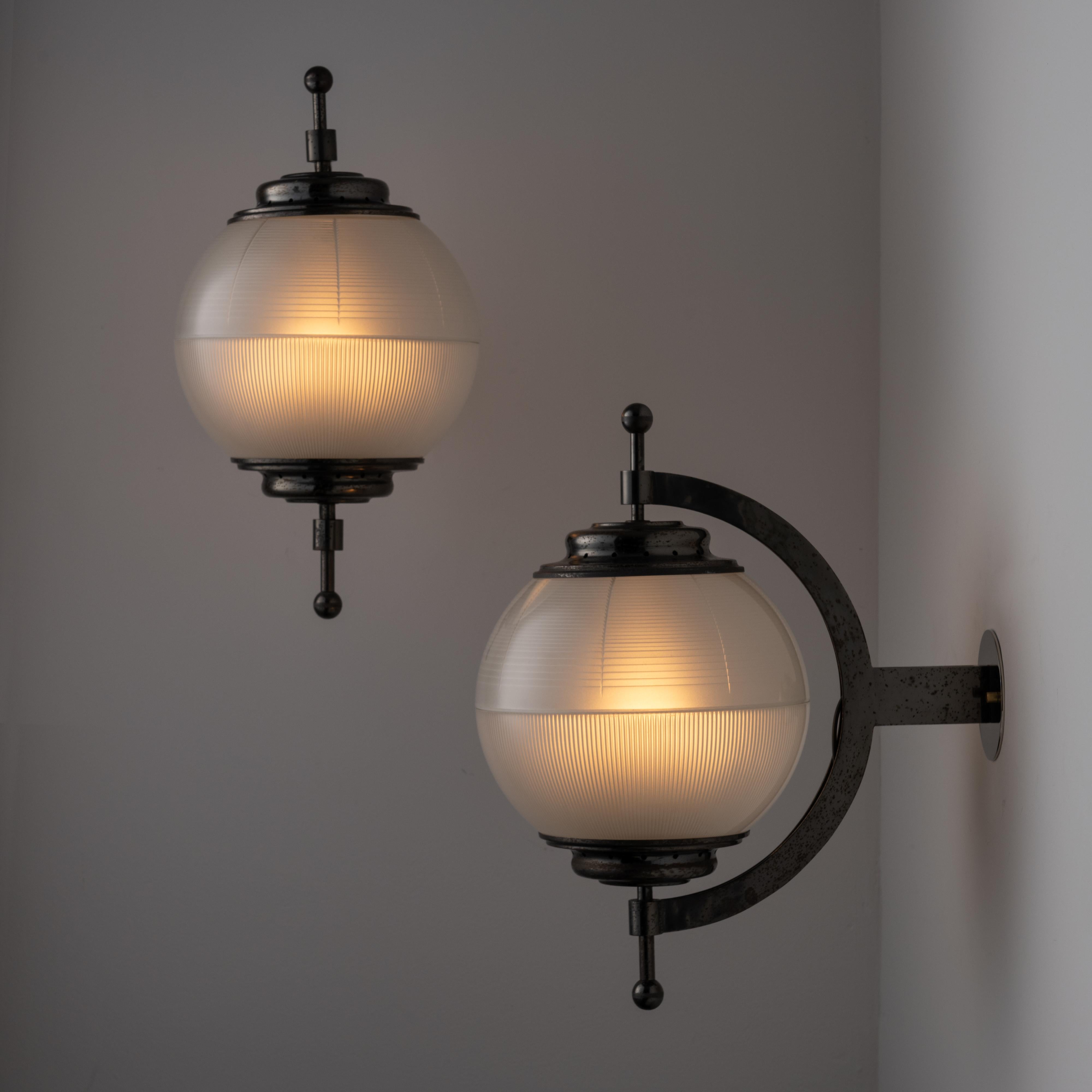 Sconces by Adrasteia. Designed and manufactured in Italy, circa the 1950s. Reeded glass half domes are interspersed by highly detailed blackened polished nickel armatures. Very striking architectural light fixtures. Each fixture holds a single E27