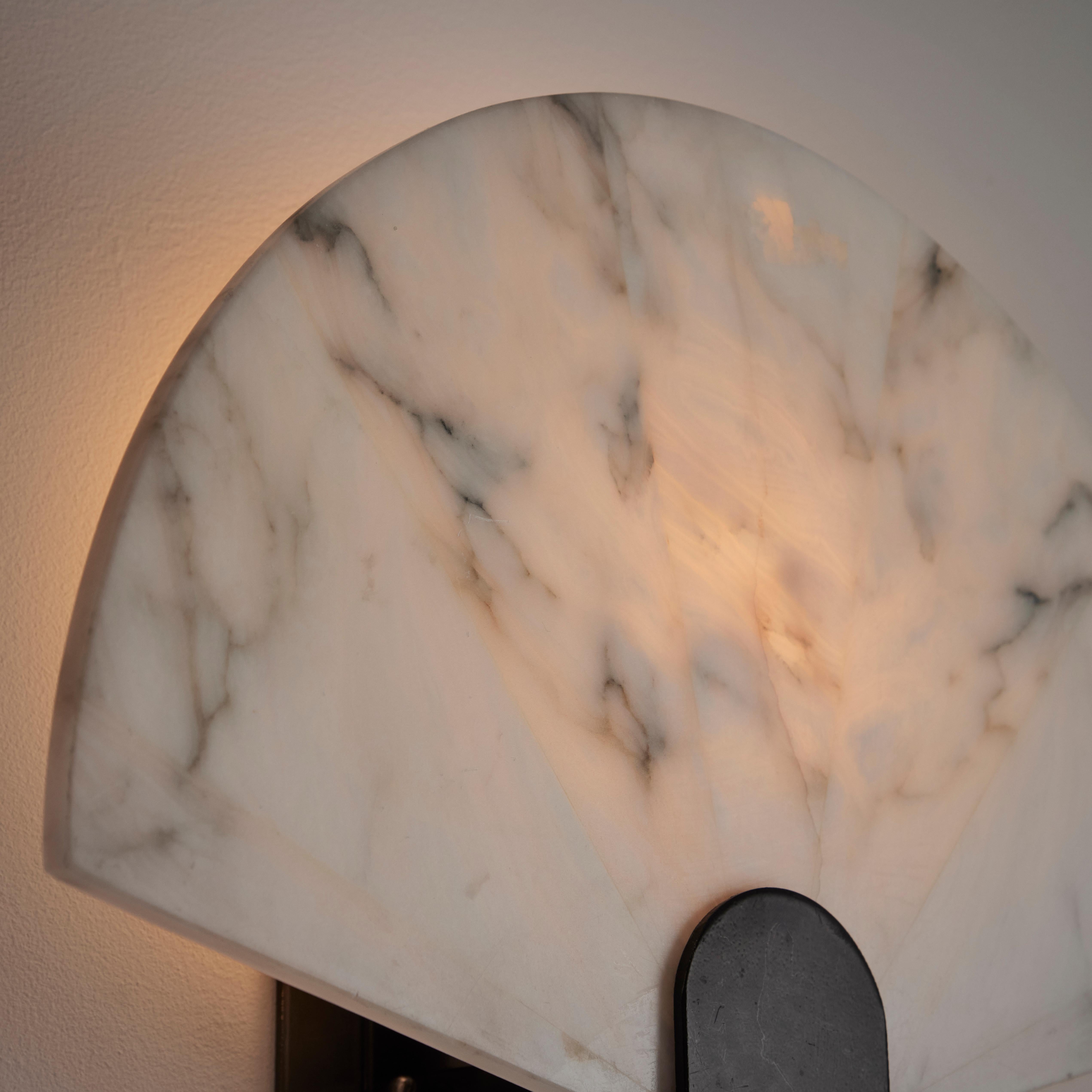 Sconces by Angelo Mangiarotti for Skipper. Designed and manufactured in Italy, circa the 1980s. A semicircle alabaster fan wall sconce with a minimal steel frame; simple and strikingly gorgeous. Each sconce holds one E27 socket, adapted for the US.