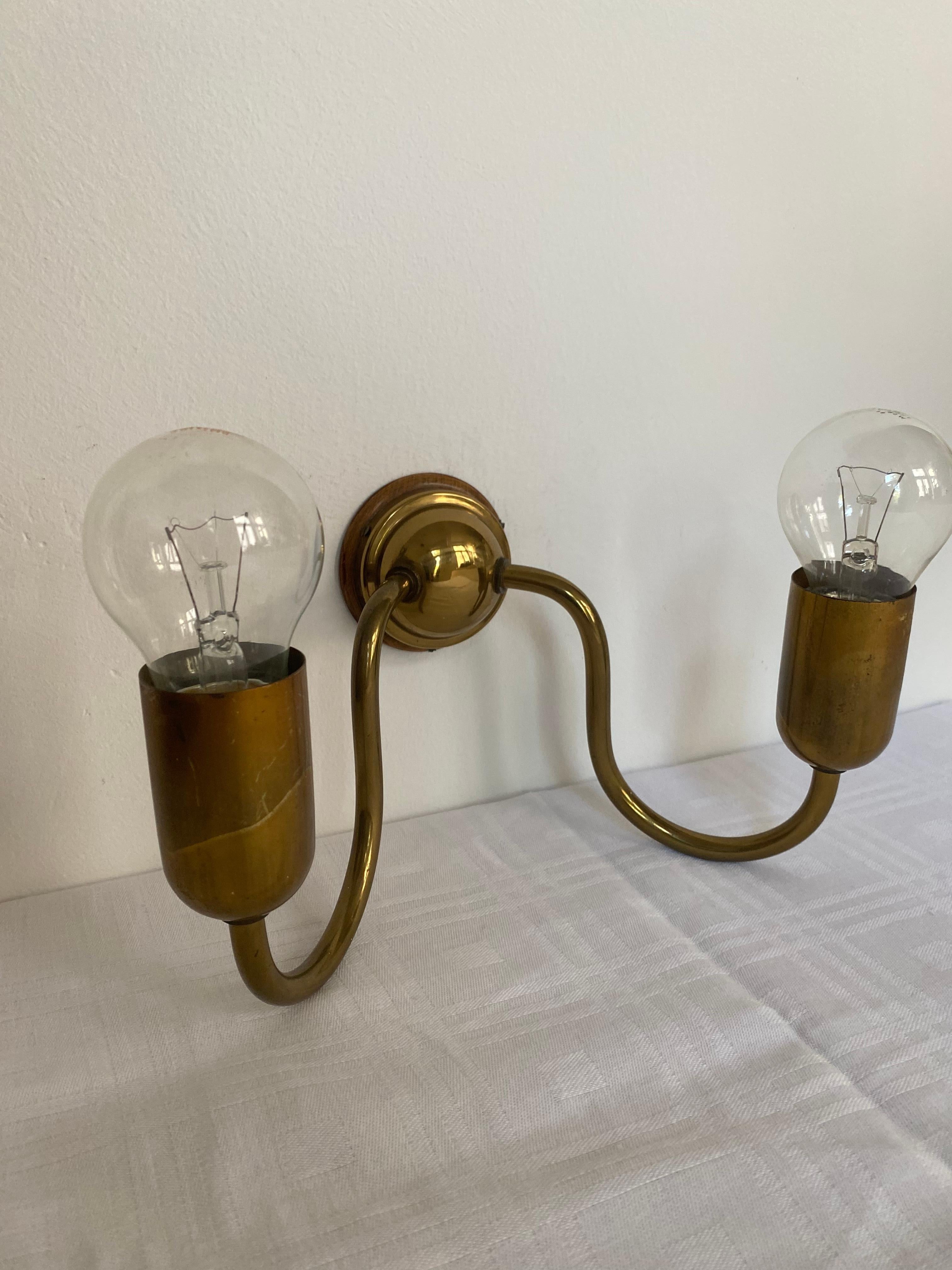 Rare sconces by the Austrian designer Josef Frank. Designed and made for the House and Garden shop in Vienna in the 1930‘s. This pair of sconces coms with the original wooden fixture to the wall and orig. weird. Weiring can be easily exchanged into