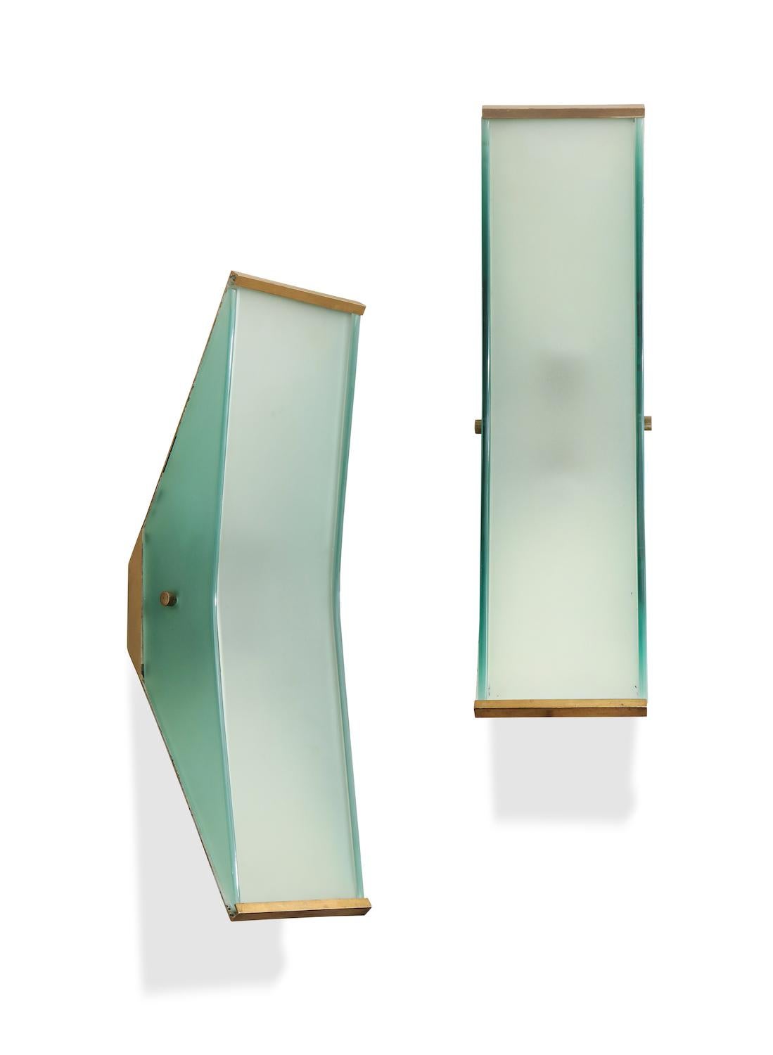 Rare wall sconces #2135 by Max Ingrand for Fontana Arte. Satin glass panels of natural and pale green colors. Polished brass structure. 2 candelabra sockets per sconce. Published: Fontana Arte 4, makers self-published catalog. Pg. 55. Provenance: