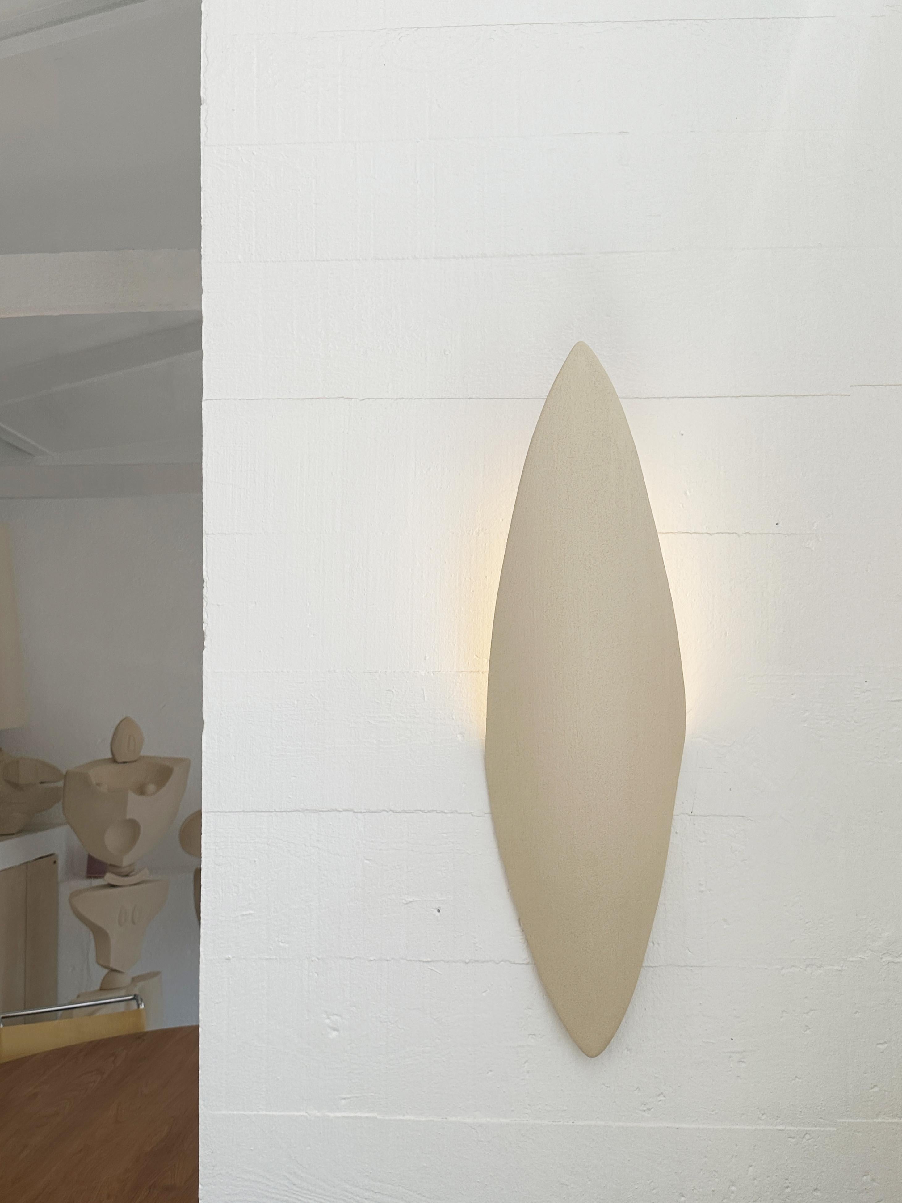 Sconces Minimalist Wall Lamp by Olivia Cognet
Dimensions: W 80 x D 30 x H 25 cm
Materials: Ceramic.


Each of Olivia’s handmade creations is a unique work of art, the snapshot of a precious moment captured in a world of fast ‘everything’.
Since