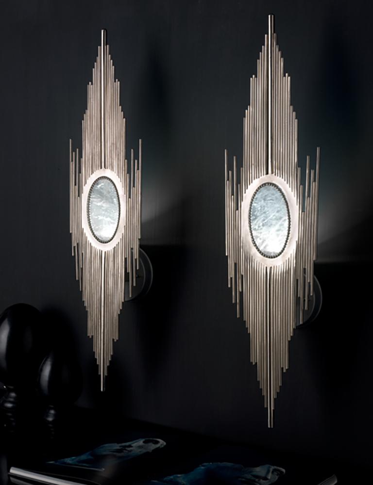 Wall lamp made of hand soldered, brushed and chromed iron tubes. Central part in natural rock crystal.