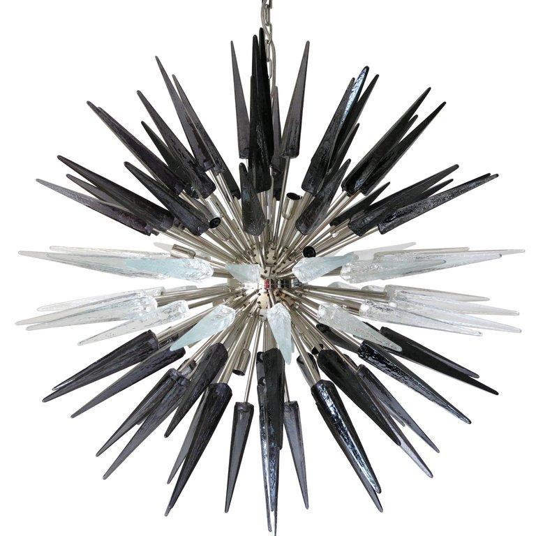 Italian modern Murano chandelier shown in clear and black Murano glass shards, mounted on chrome metal frame / Designed by Fabio Bergomi for Fabio Ltd / Made in Italy
16 lights / E12 or E14 type / max 40W each
Diameter: 48 inches / Height: 48 inches