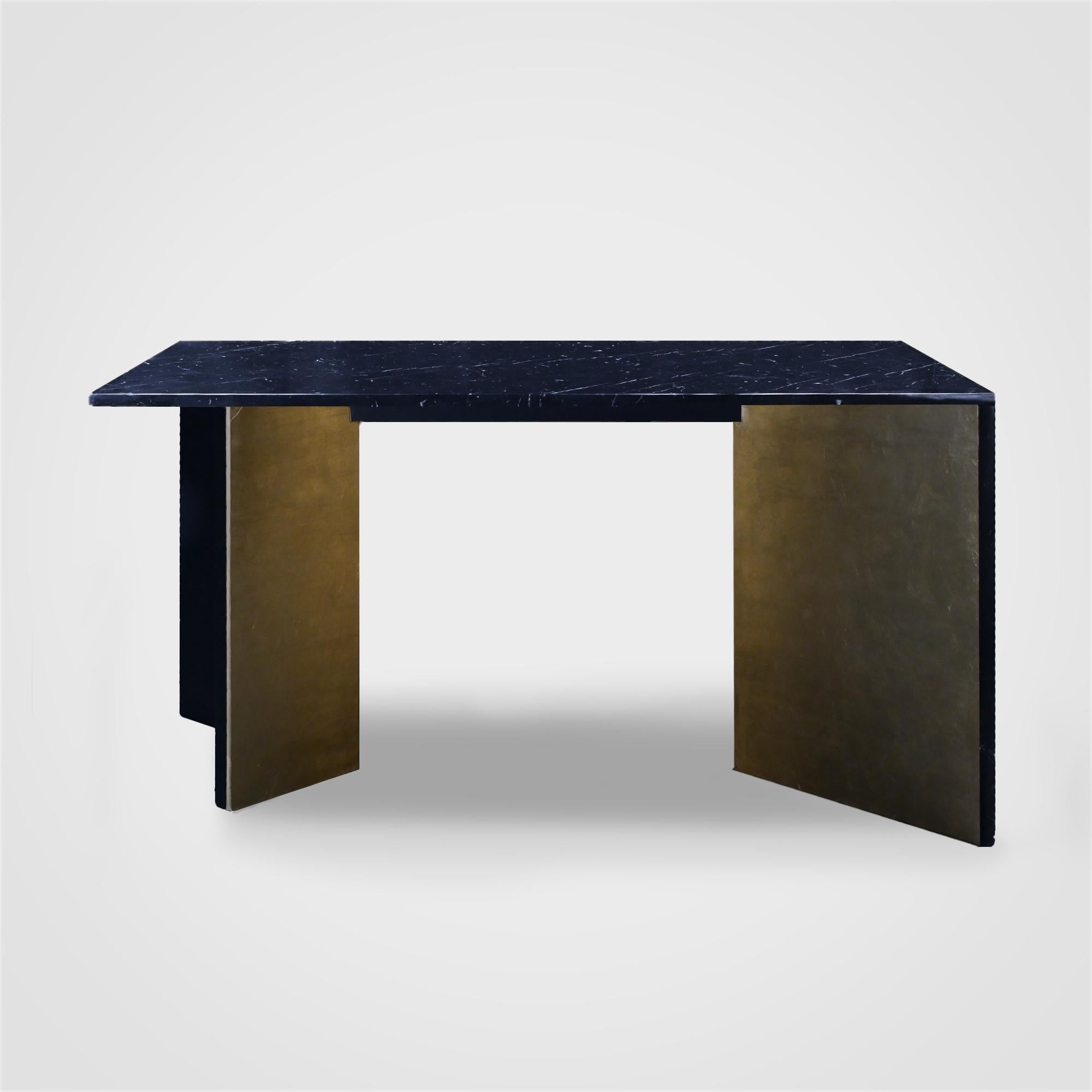 Refined beauty in its element, the Scorcio Dining Table is made of Nero Marquinia marble and Steel , with the legs adorned in gold leaf. Depending on the viewer's perspective, the symmetry of the legs creates a unique opening that acts as a visual