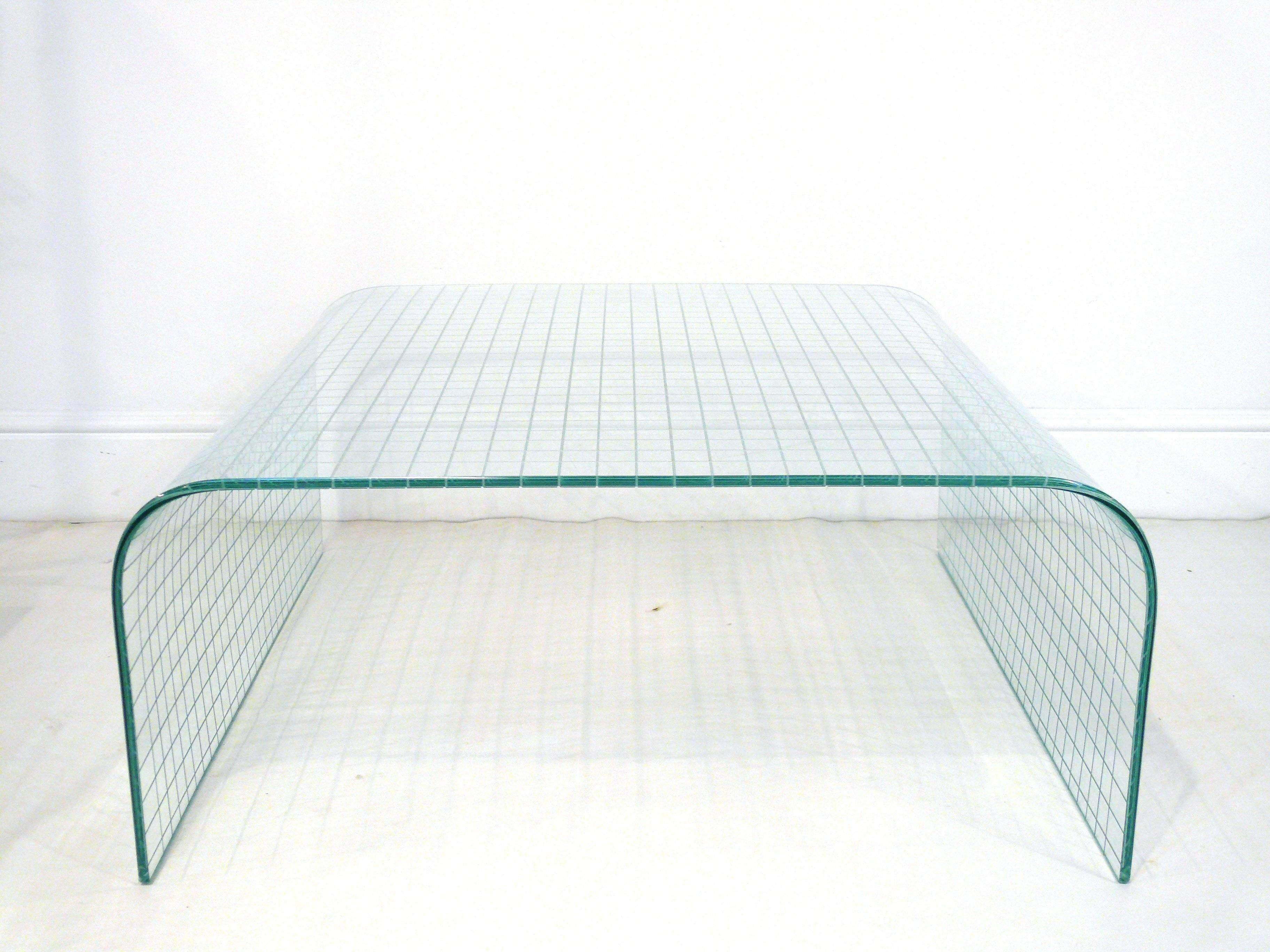 Fiam Style scored glass waterfall coffee table. Table has a unique grooved grid pattern throughout.