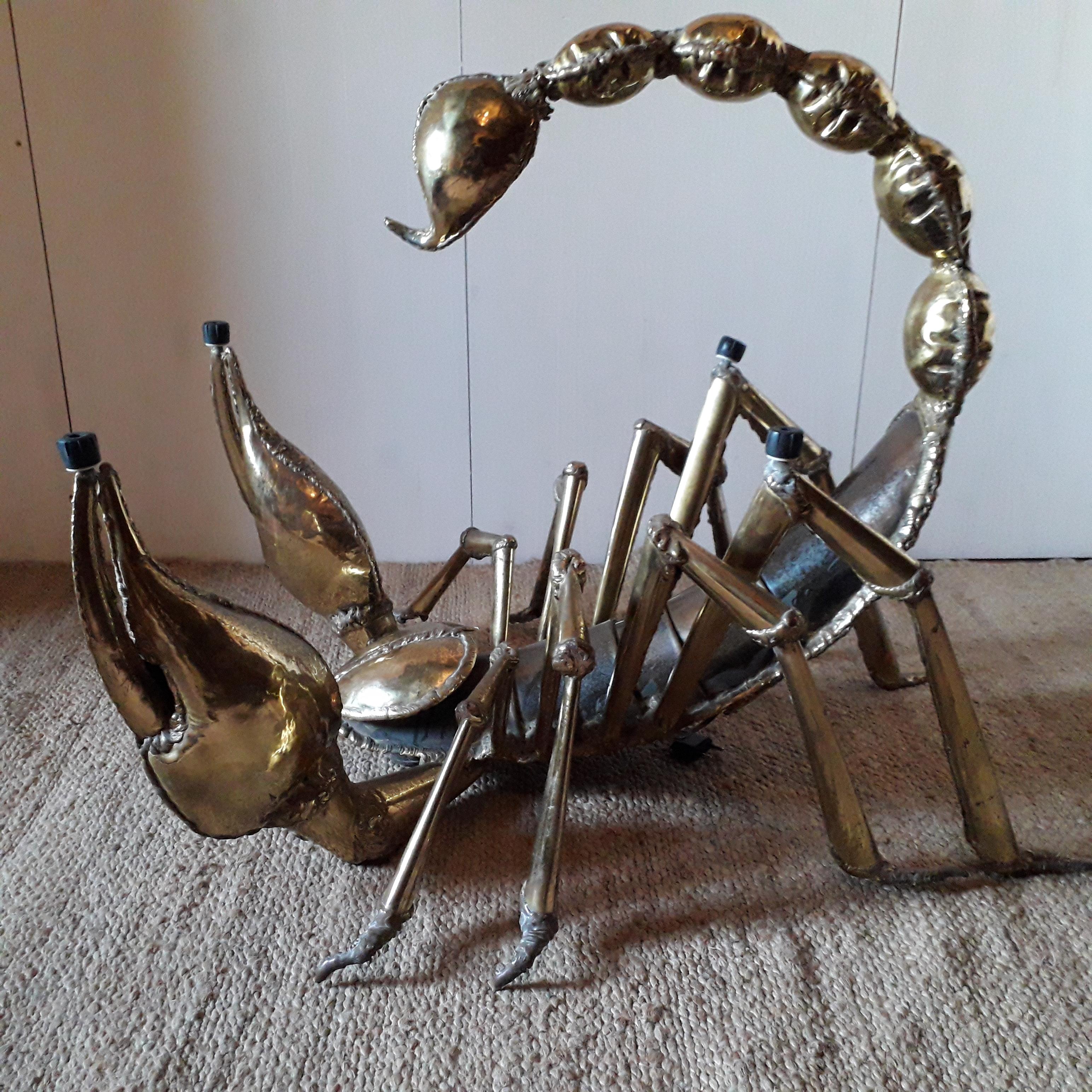 Coffee table depicting a scorpion with his tail erected. Tail lit by a light bulb.
New translucent glass top. Polished and hammered brass. Slight patina of use.
Designer: Jacques Duval Brasseur,
circa 1970. Comes from an apartment in