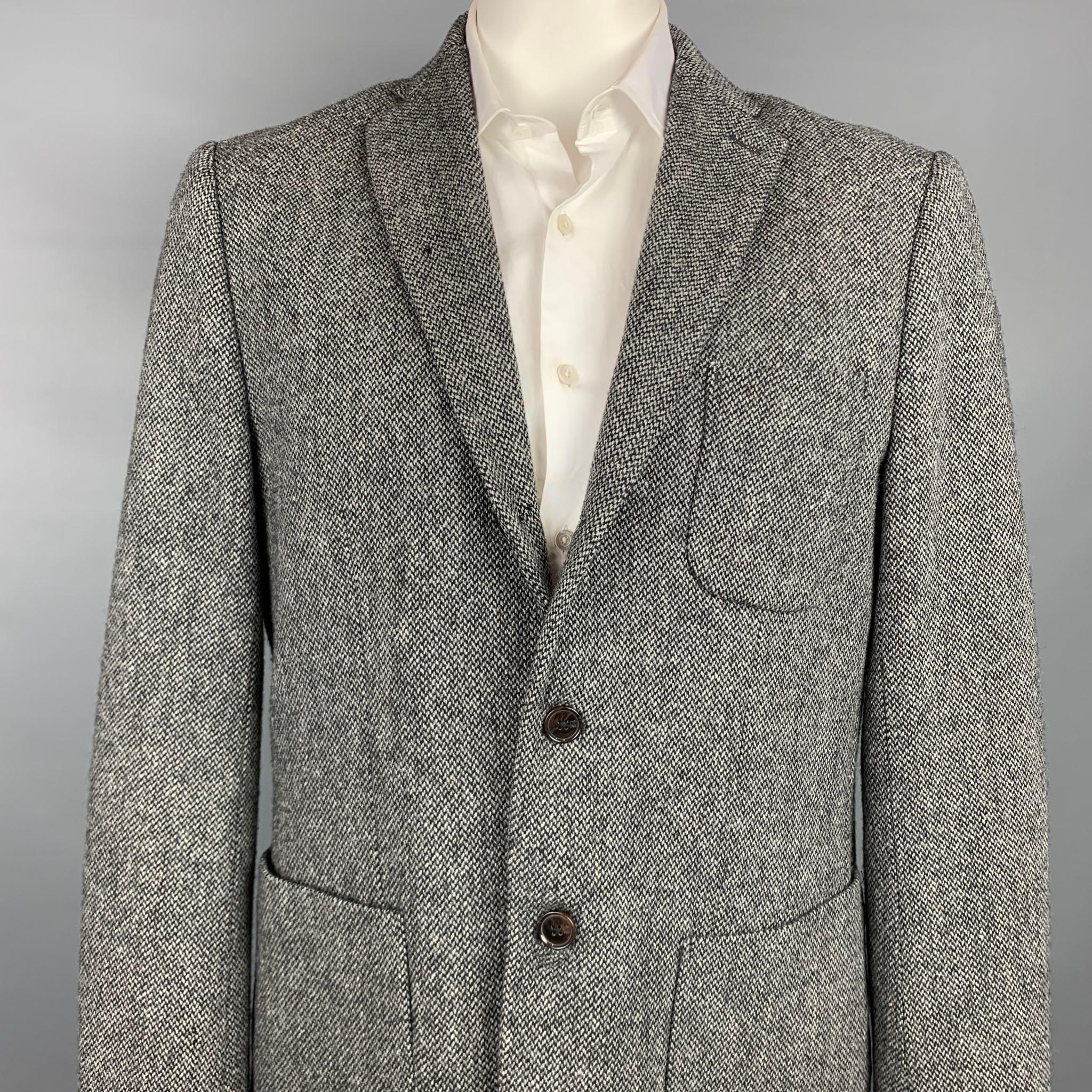 SCOTCH AND SODA sport coat comes in a grey & black wool / polyester with a half liner featuring a notch lapel, patch pockets, and a three button closure.

Very Good Pre-Owned Condition.
Marked: XXL/54

Measurements:

Shoulder: 19.5 in.
Chest: 44