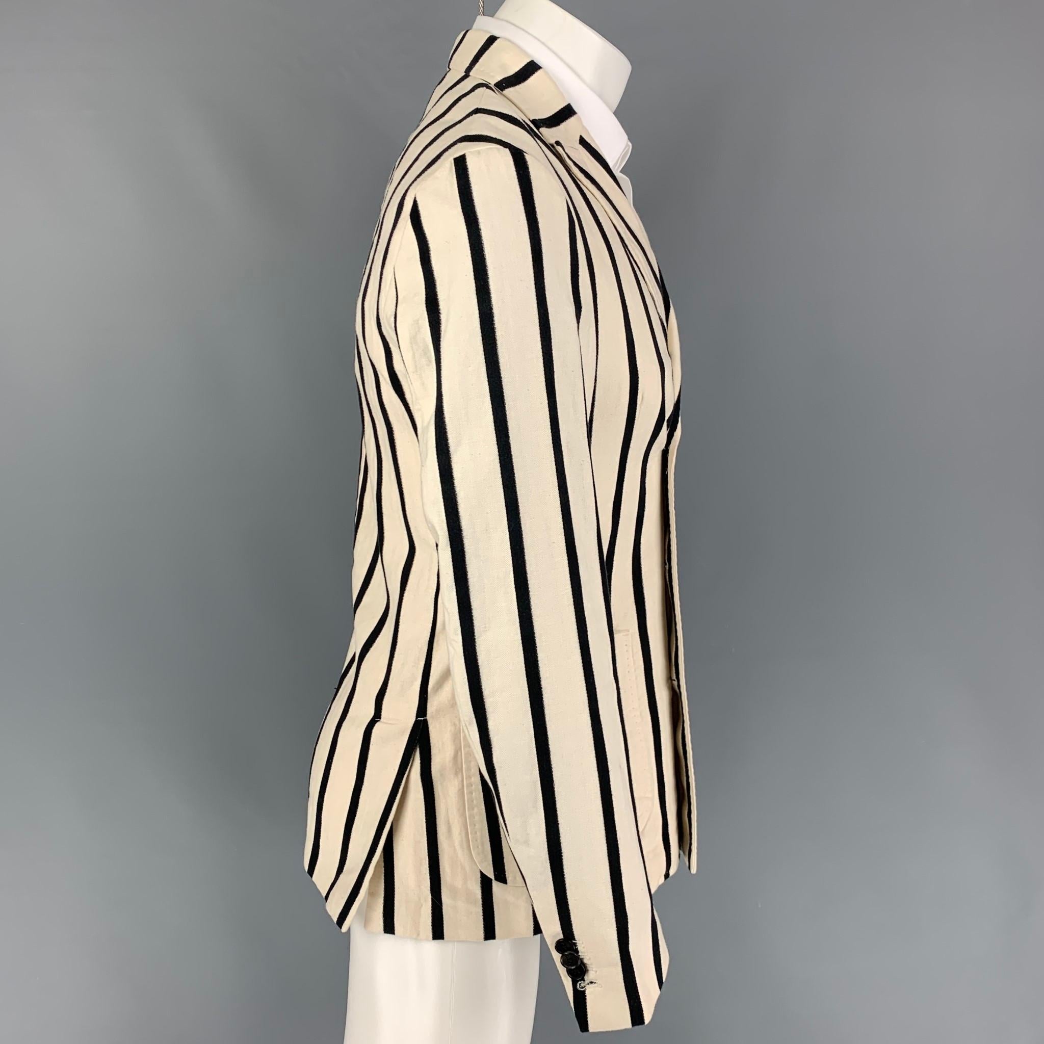 SCOTCH AND SODA sport coat comes in a beige & black stripe cotto / linen with a half liner featuring a peak lapel, patch pockets, double back vent, and a double breasted closure. 

Very Good Pre-Owned Condition.
Marked: M

Measurements:

Shoulder: