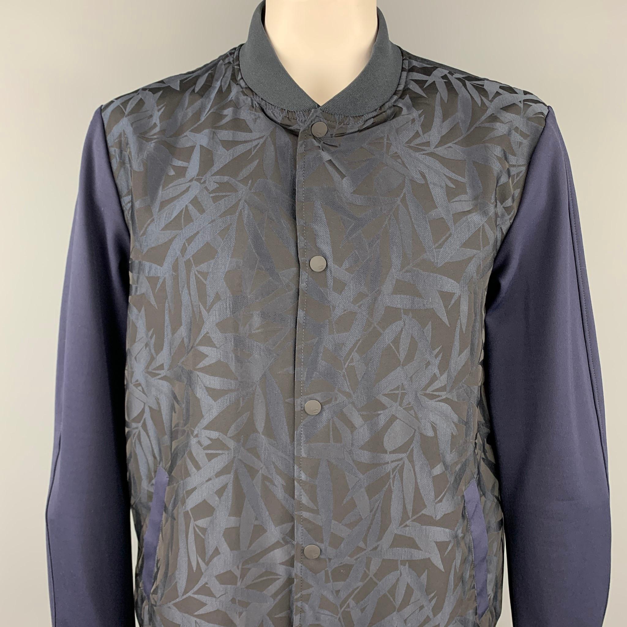 SCOTCH AND SODA jacket comes in a navy jacquard polyester featuring a bomber style, slit pockets, and a snap button closure. 

New With Tags.
Marked: XXL

Measurements:

Shoulder: 20 in.
Chest: 45 in.
Sleeve: 29 in.
Length: 29.5 in. 
