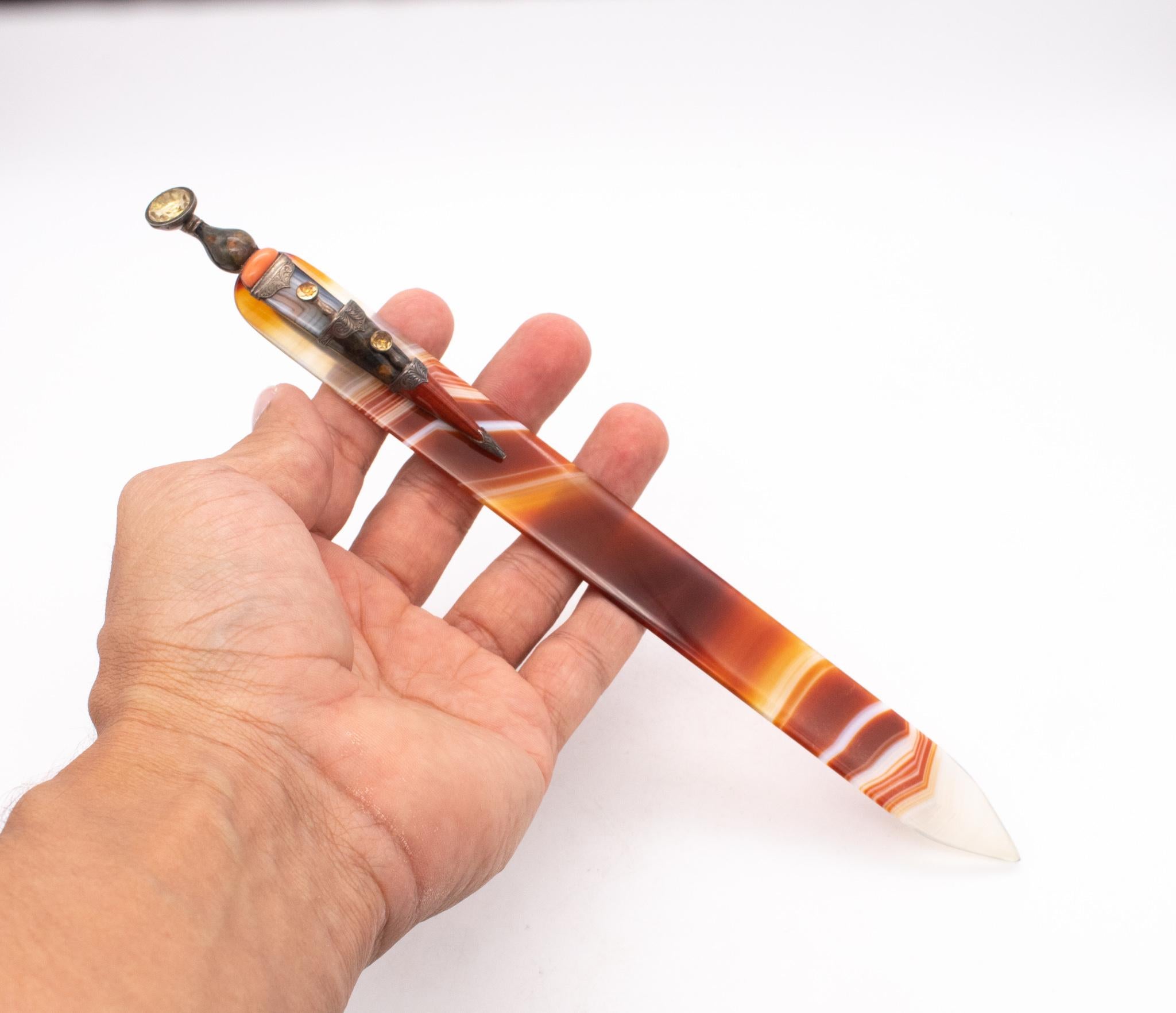 A jeweled gem-set Scottish dirk letter opener in Agate.

Fabulous and unusual antique letter opener made in Scotland, between the 1880 and 1900. This one-of-a-kind piece was designed in the shape of a Scottish dirk (dagger) and was entirely