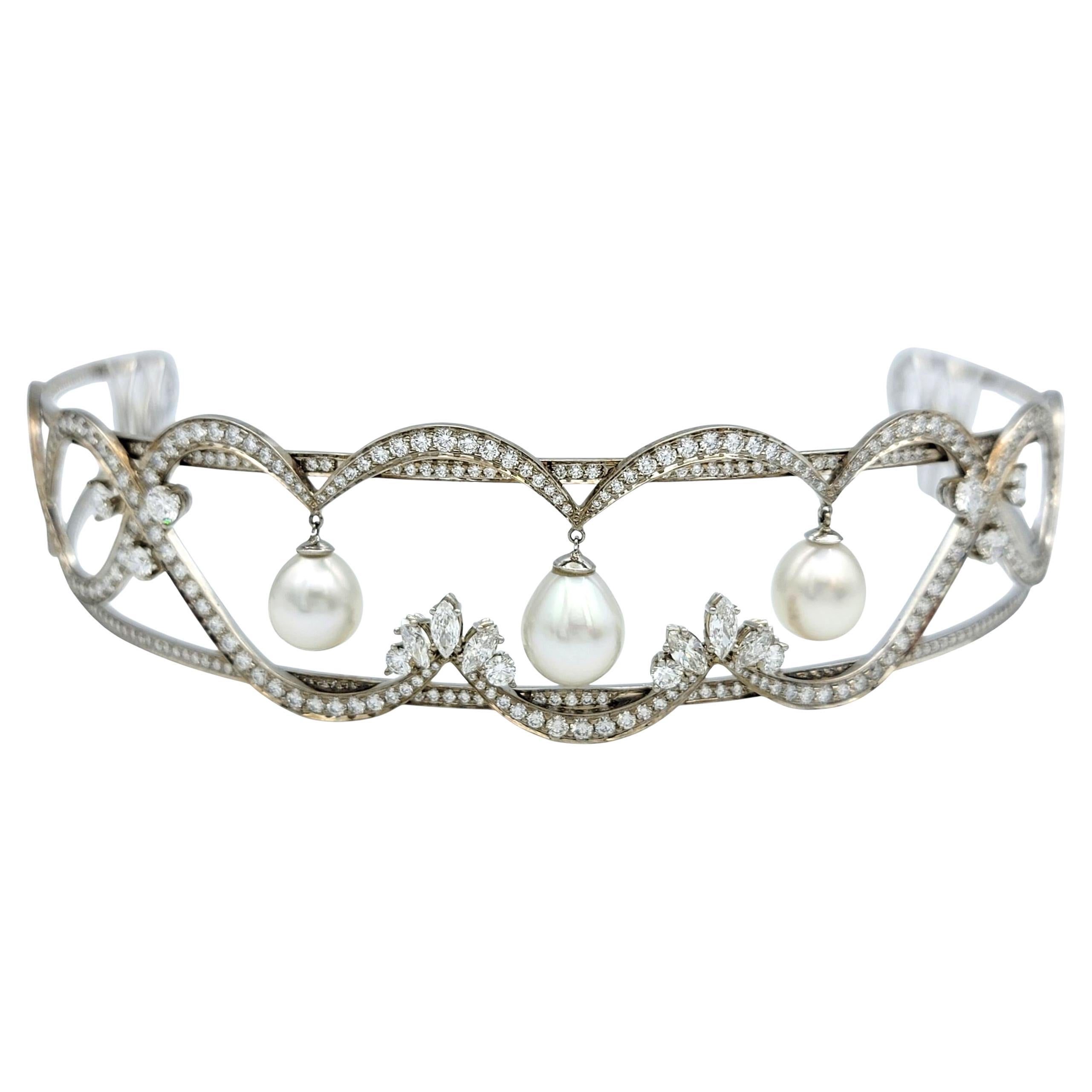 This regal tiara, designed by Scott Gauthier, is a breathtaking composition of elegance and grace. Scrolling diamond-set ribbons weave across the crown in an openwork silhouette, with three luminous drop-shaped pearls suspended from the central
