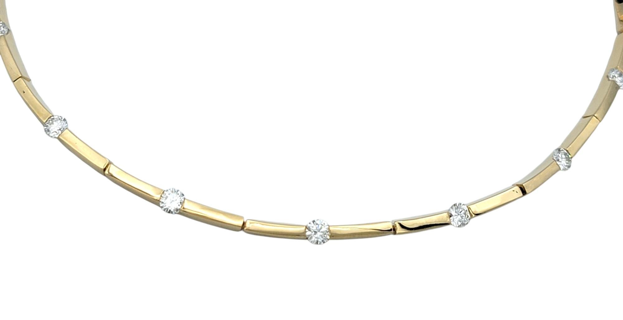 This elegant choker necklace exudes understated luxury with a refined silhouette crafted in 14 karat yellow gold. The design features sleek bar-style links that form a gently contoured arc around the neckline, creating a seamless and graceful drape.