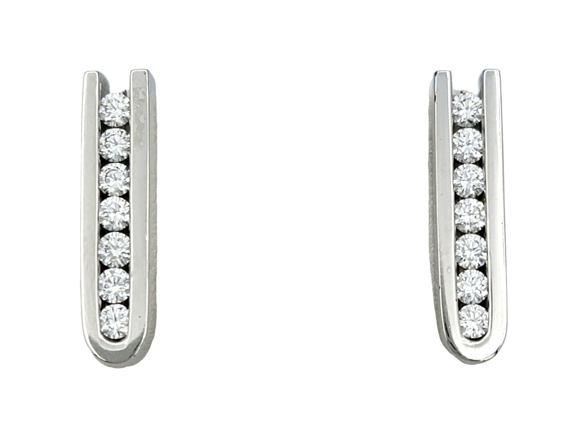 This elegant set of white gold diamond drop earrings designed by Scott Gauthier are a true testament to refined sophistication. Each earring features a vertical row of seven dazzling diamonds, meticulously channel set to ensure maximum brilliance