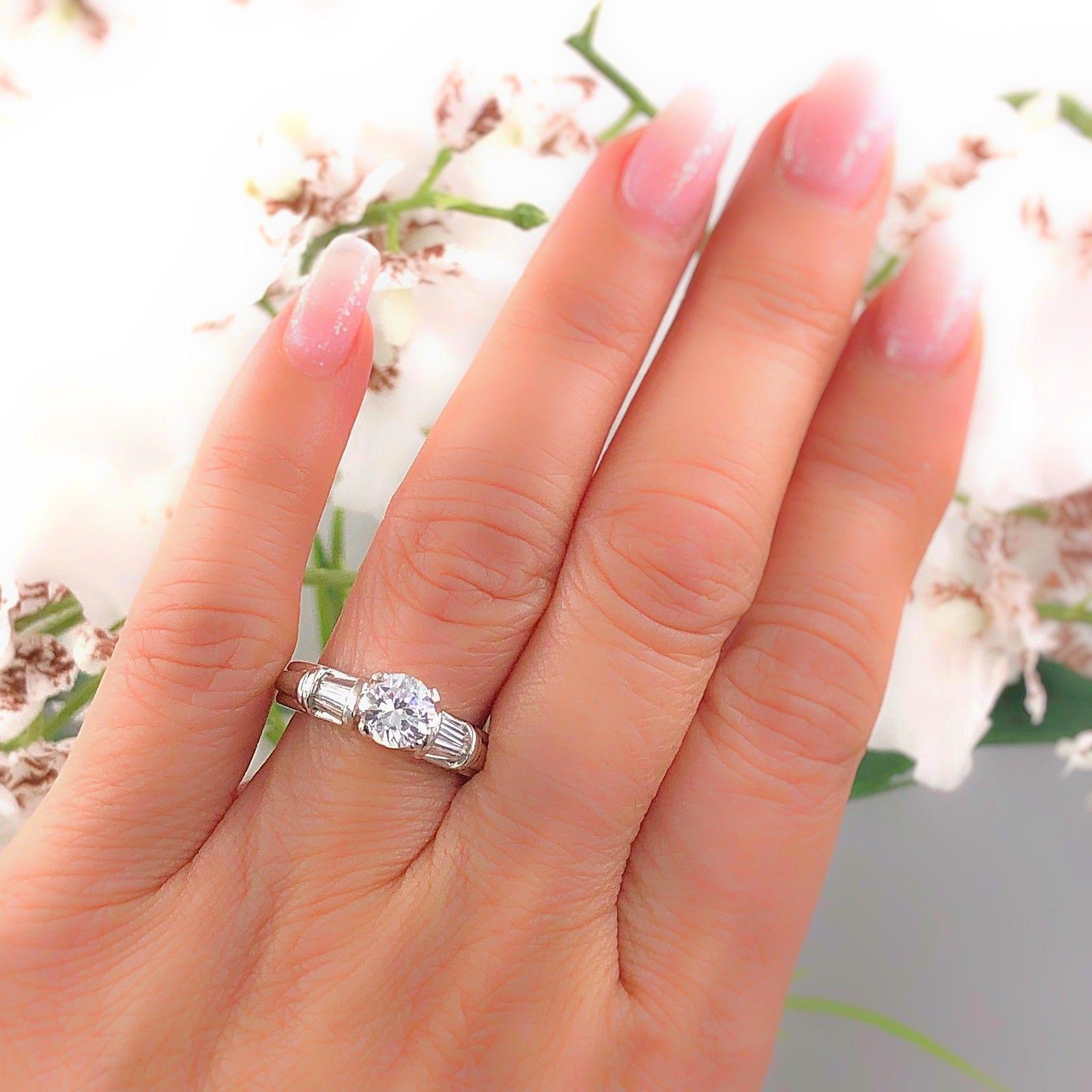 Brand: Scott Kay
Style:  Solitaire with Baguettes Semi Mount
Metal:  Platinum
Size:  6.75 - sizable
Total Carat Weight:  0.28 tcw
Diamond Shape:  Center is Currently a CZ - Will Hold 1.00ct Round
Accent Diamond Color & Clarity: Tapered Baguettes
