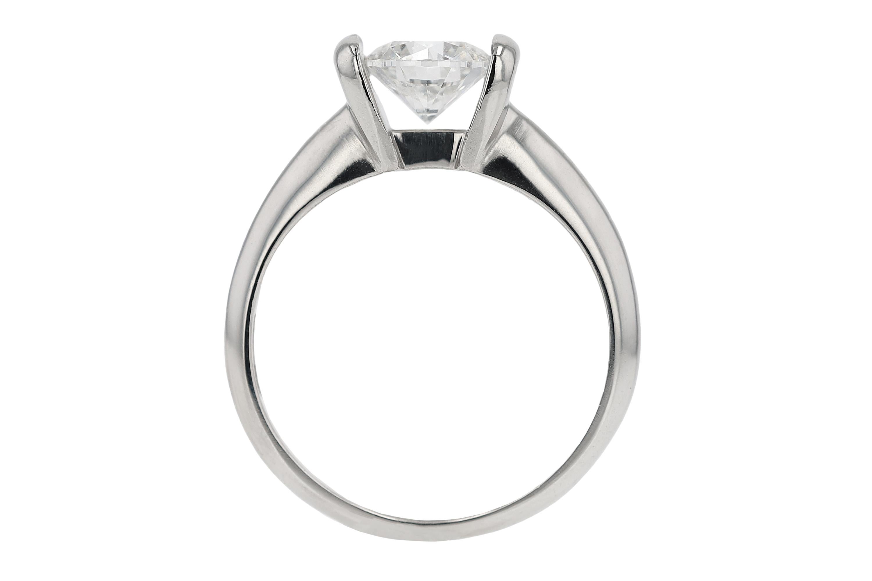 A magnificent solitaire engagement ring, vintage from the Scott Kay collection. Reflecting a minimalist design, the single stone setting centers on a 1 carat natural diamond, certified by the International Gemological Institute as E color