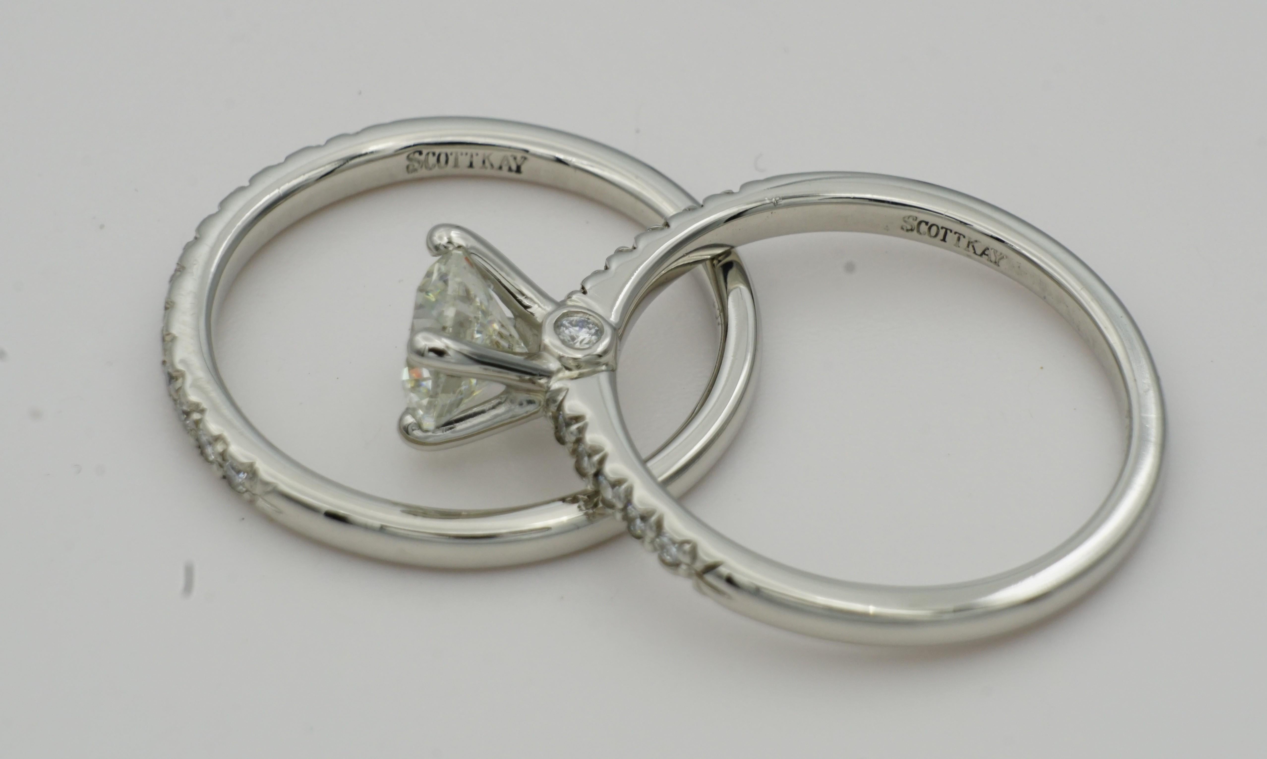 Designer Scott Kay Platinum Wedding set with a  1.00ct Round Brilliant Center Stone Diamond Wedding Set. The center diamond is H in color, SI2 in clarity, and well-cut. The engagement ring has 12 small round brilliant diamonds that are approximately