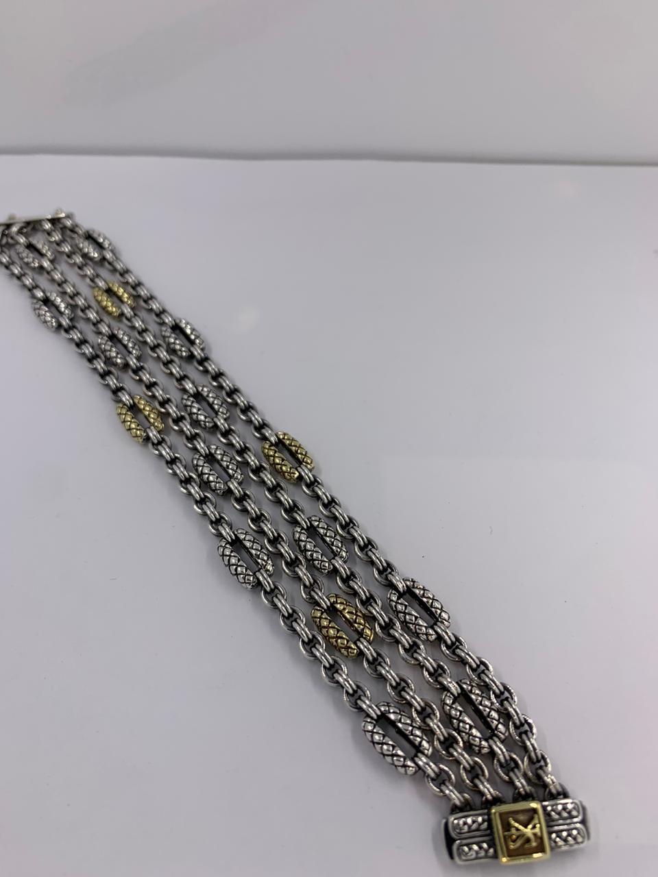 Scott Kay Silver and Gold Bracelet
4 row silver and 18kt gold link bracelet
SKS-10003