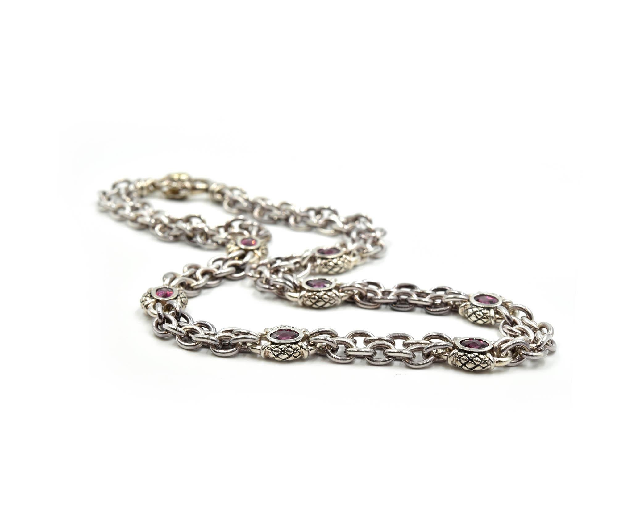 A beautiful piece by designer Scott Kay! This necklace consists of sterling silver oval links and bezel set rhodolite garnets. Each of the seven rhodolite garnets are oval cut and measure approximately 6.23mm long x 4.53mm wide. The garnets are set
