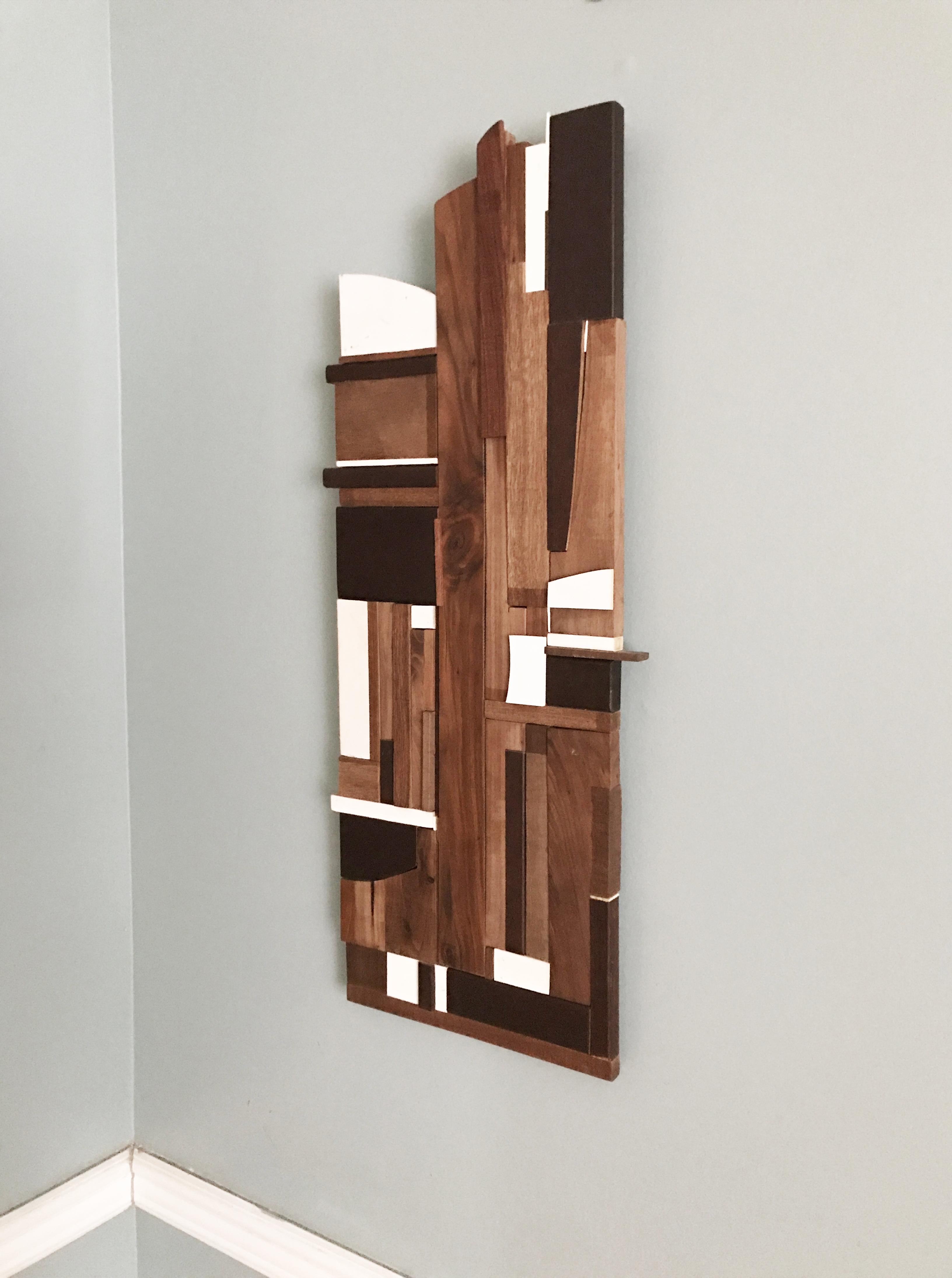 <p>Artist Comments<br />District 1 is a mixed media abstract wall sculpture made from a variety of repurposed woods including pine, cherry, mahogany and walnut.  The piece uses both finished wood and raw textured wood.  It features a simple vertical