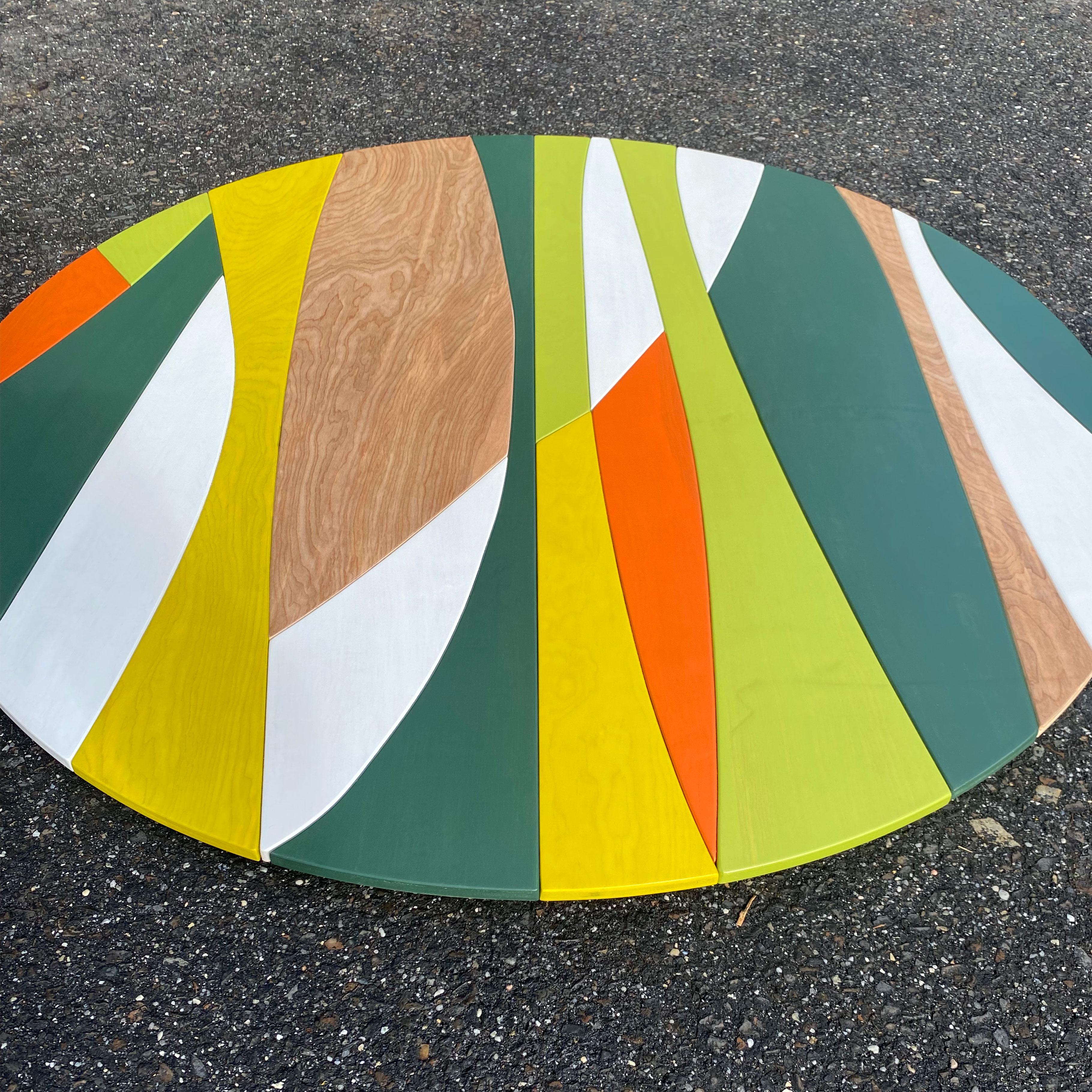 Solar Circle (Luau color way) is a modern, abstract, wood wall sculpture made from acrylic, birch and satin lacquer. The piece was inspired by the flowing organic lines of mid century modern design which combined bold colors with the warmth of wood