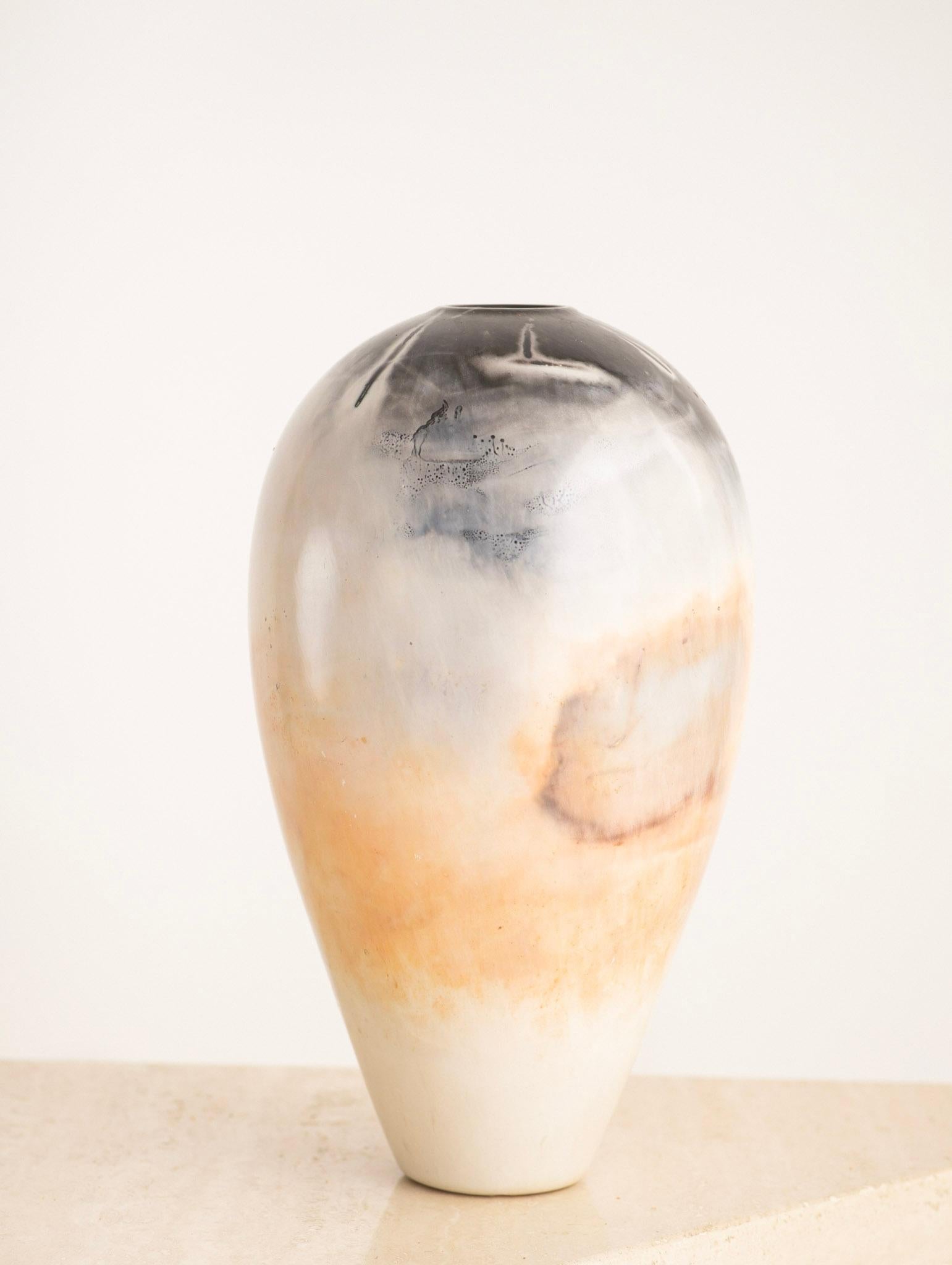 Elegant “burnished and saggar fired” porcelain vase by Massachusetts-based artist Scott Tubby. Beautiful painterly like abstract pattern achieved by chemical reactions during firing. Signed “Scott Tubby.”