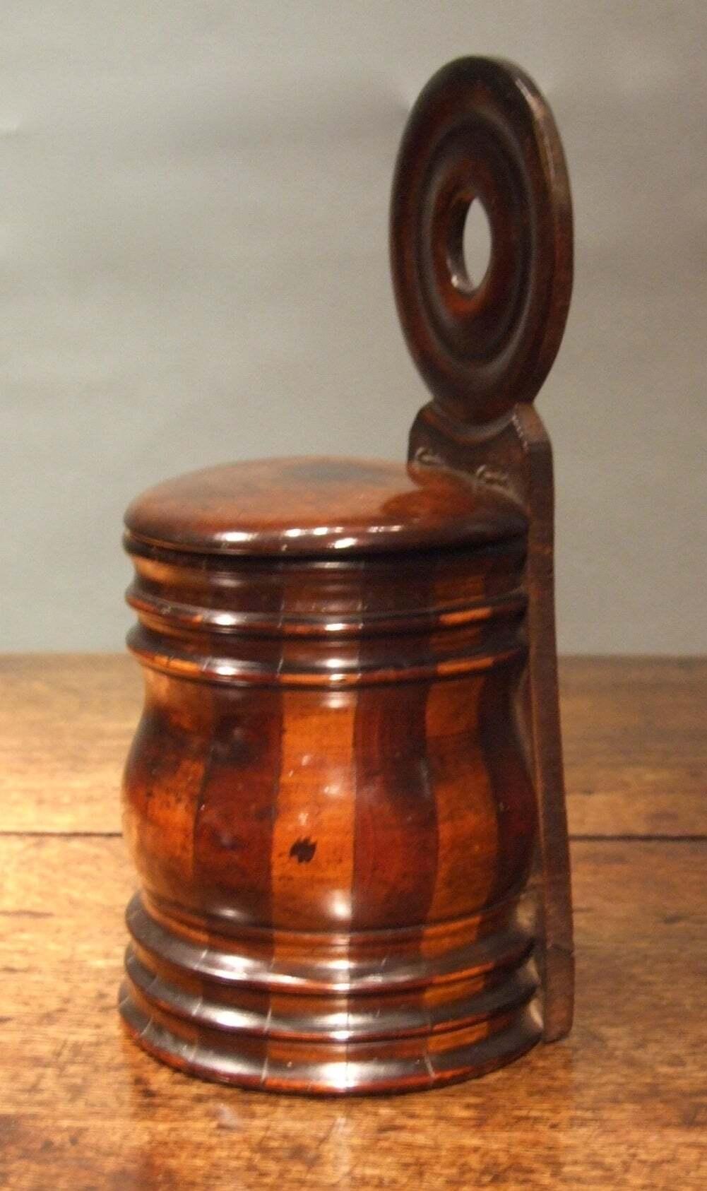 Good mid 19th Century turned wall mounted salt box, fashioned with alternating bands of sycamore and mahogany and having good crisp turned details and an exceptional patinated surface

Treen