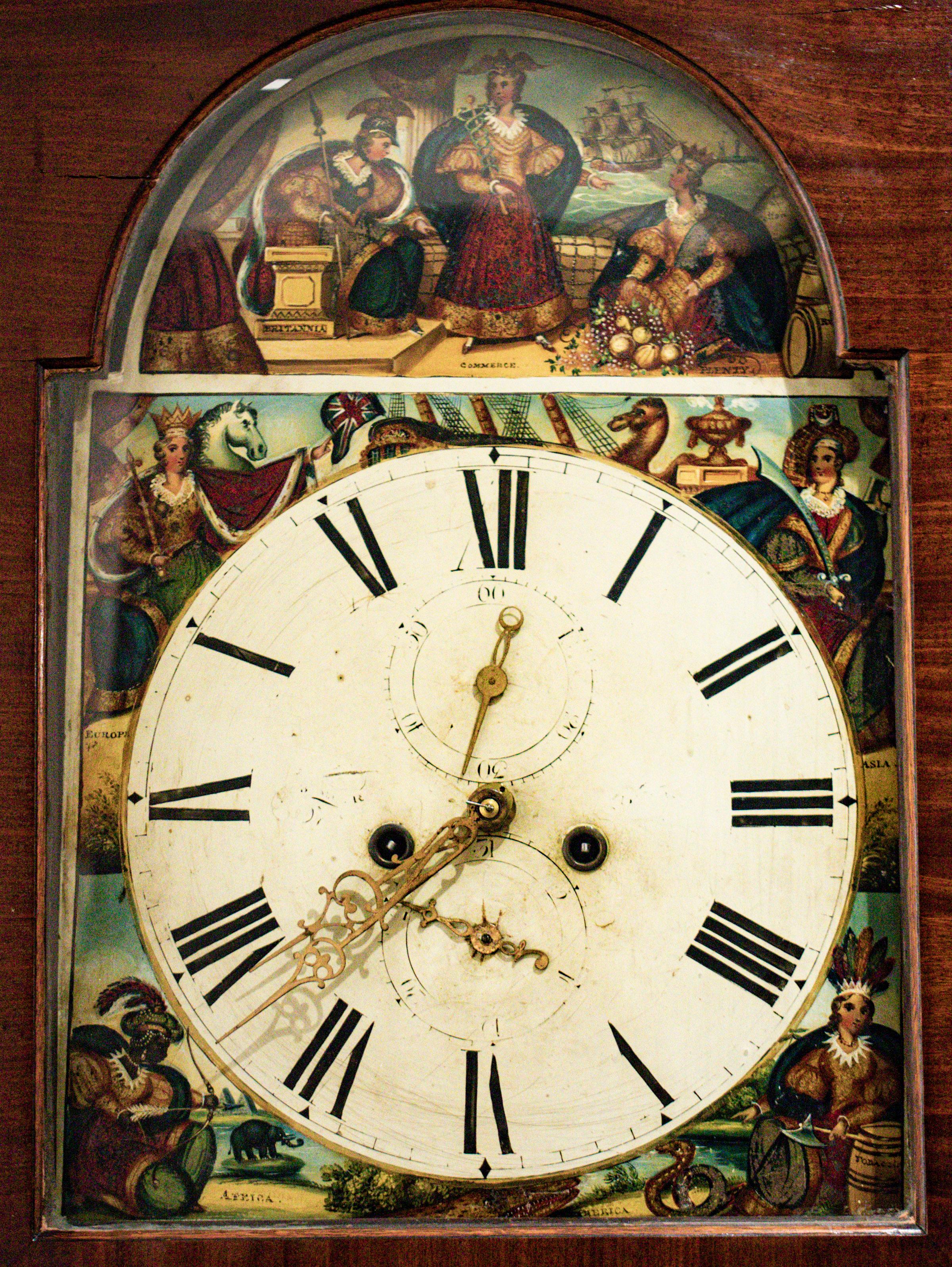 Scottish mahogany tall case clock, circa 1830, having painted spandrels featuring personifications of the continents Asia, America, Africa, and Europe, the arch painted with allegorical figures of Britannia and others, the overall imagery marked by