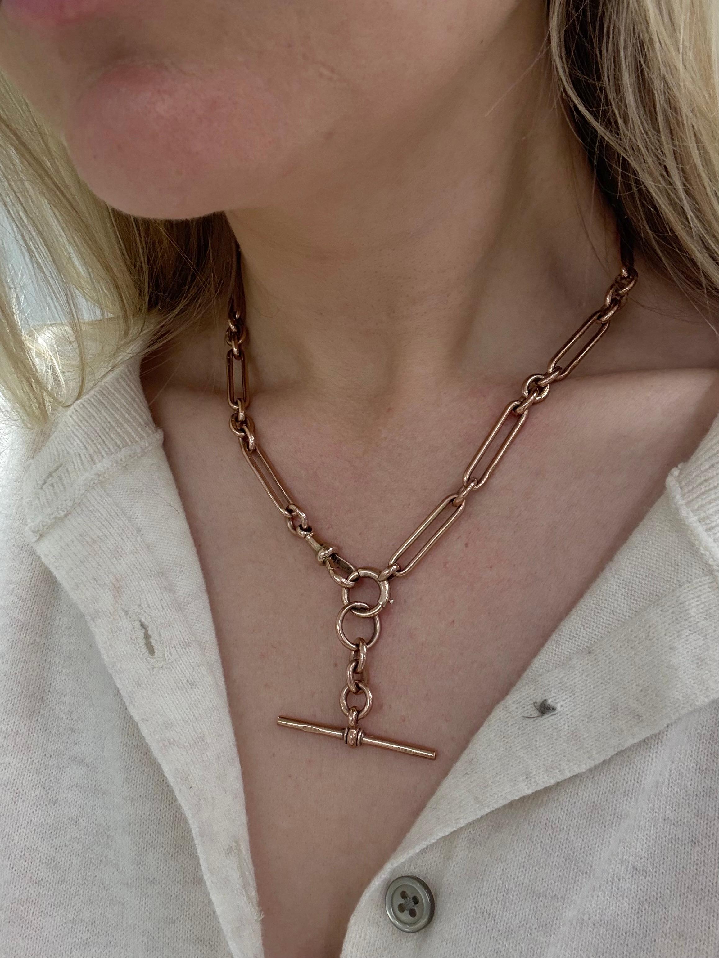 This rare watch fob necklace in a rose gold, with trombone link chain, each stamped with 9c, Albert swivel clasp and a hanging T bar attachment. 

Measurements: 17 inches long
Metal: 9 carat rose gold
Stamp: 9 .375 R.P. (Scottish Hallmarks dated