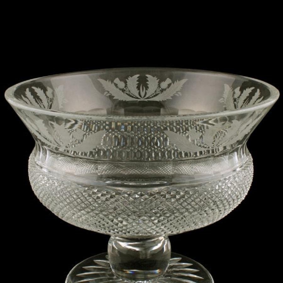 A mid 20th century Scottish cut crystal bowl.

The large bowl is thistle shaped with engraved thistle decoration and is hobnail cut.

The bowl has a rounded knop stem and the underside of the foot is star cut.

The bowl is in very good