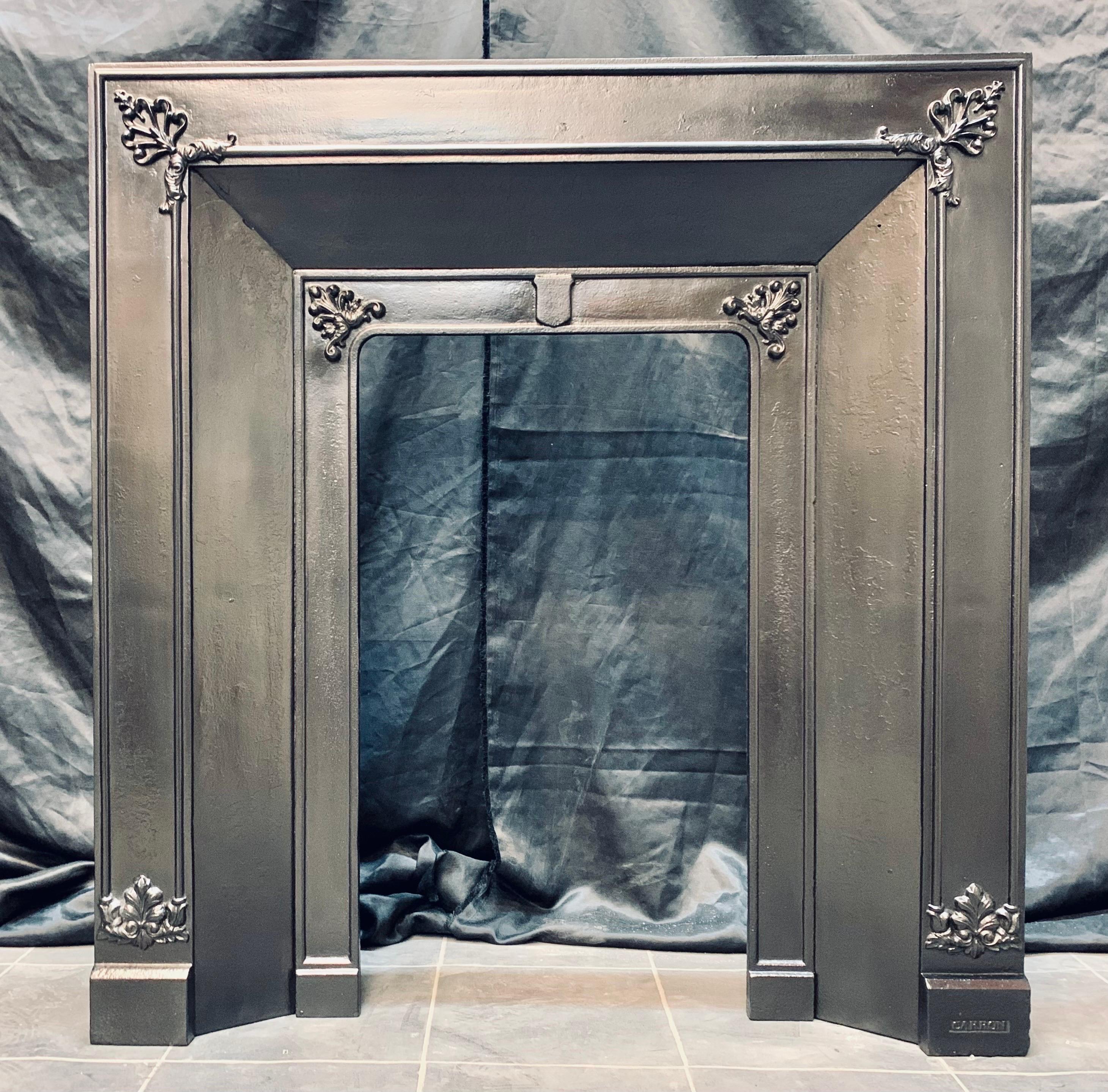 An original Scottish early 19th century cast iron fireplace insert by Carron of Falkirk. A splayed frame with high relief embellishments and a central shield. Stamped carron to the lower right base block. 

Fire opening size: 407 mm wide x 709 mm