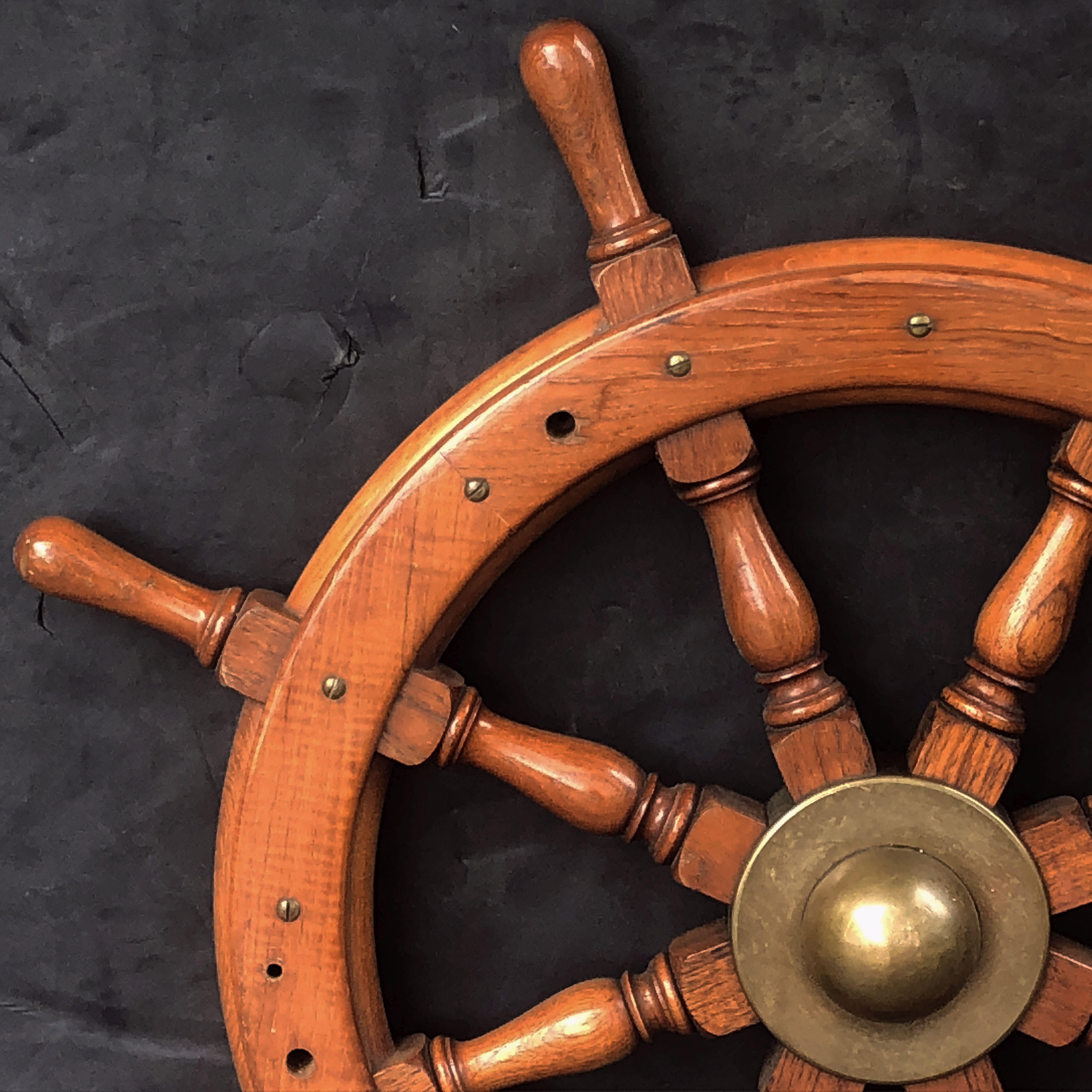 A fine Scottish ship's wheel of turned mahogany and brass, featuring an eight spoke wheel around a heavy brass hub.

Overall dimensions: 36