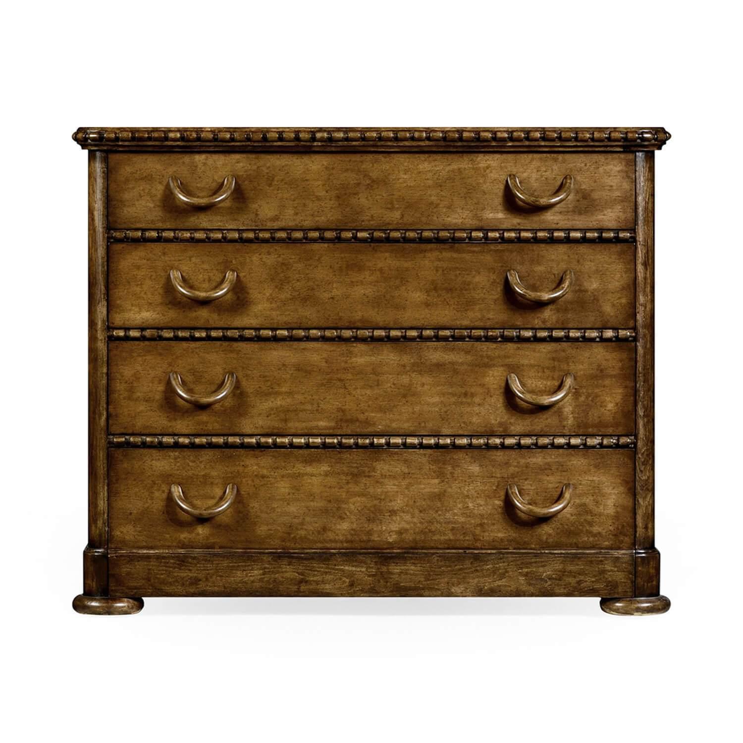 An unusual Aberfoyle (Scottish) greyed fruitwood chest of drawers. With a ribbon carved and molded edge, four graduated drawers with unique drop handles and raised on flattened melon feet.

Dimensions: 43 1/4