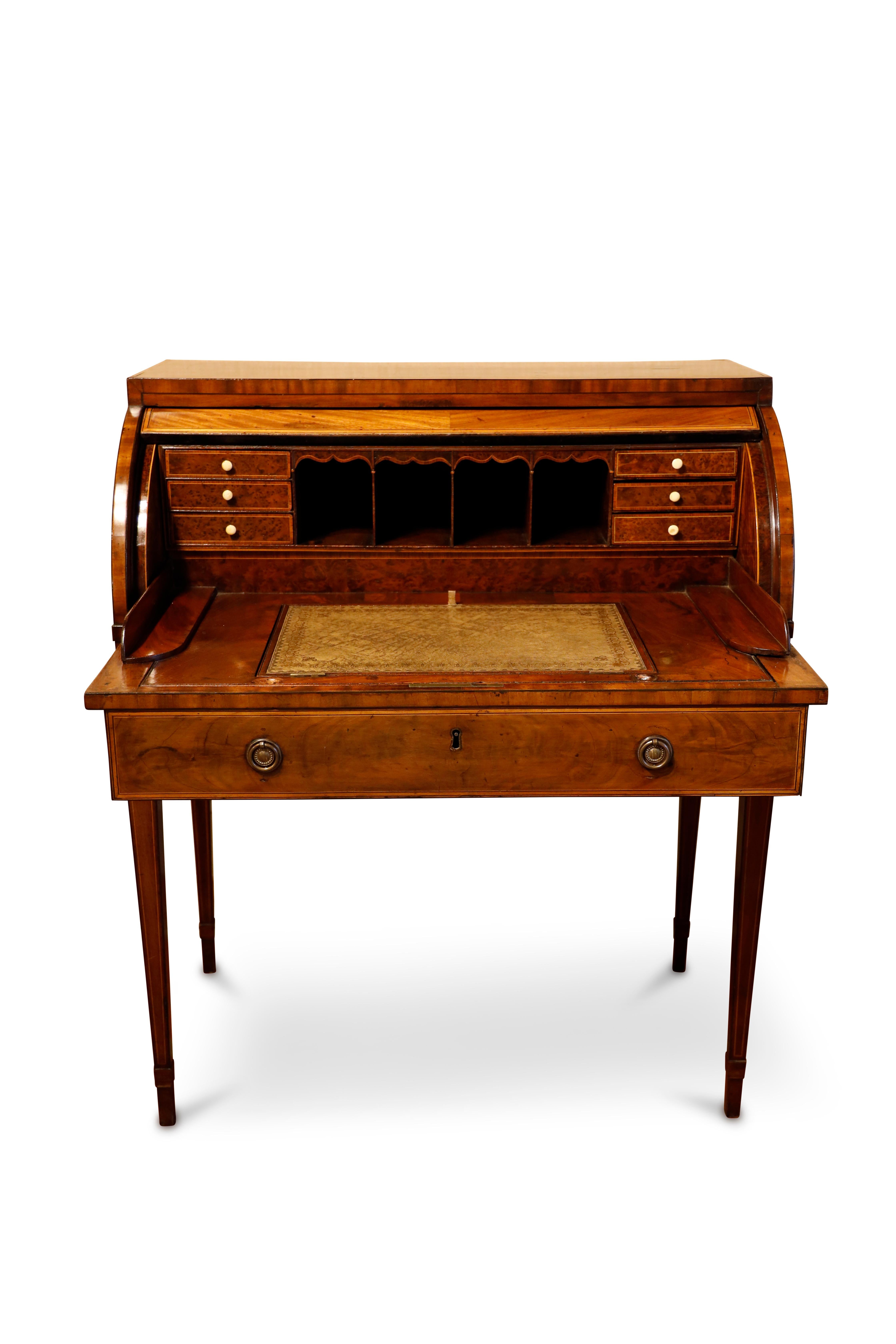 Scottish George III mahogany and sycamore banded cylinder bureau / desk.  The revolving cover encloses a leather inset, articulating writing surface and an arrangement of pigeon holes and burl yew fronted small drawers. Boxwood inlay thoughout case