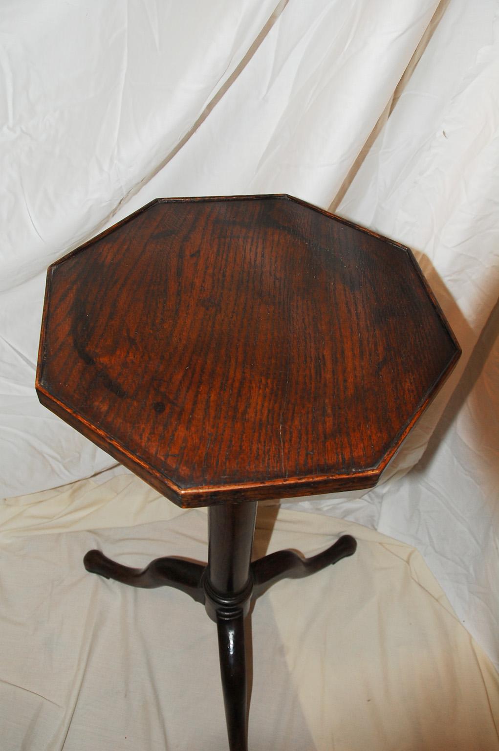 Scottish George III period Chippendale oak candlestand or torchere with octagonal low galleried top, tripod base with cabriole legs and pad feet. This handsome torchere with turned stem makes a great plant stand or a candelabra stand. It is possible