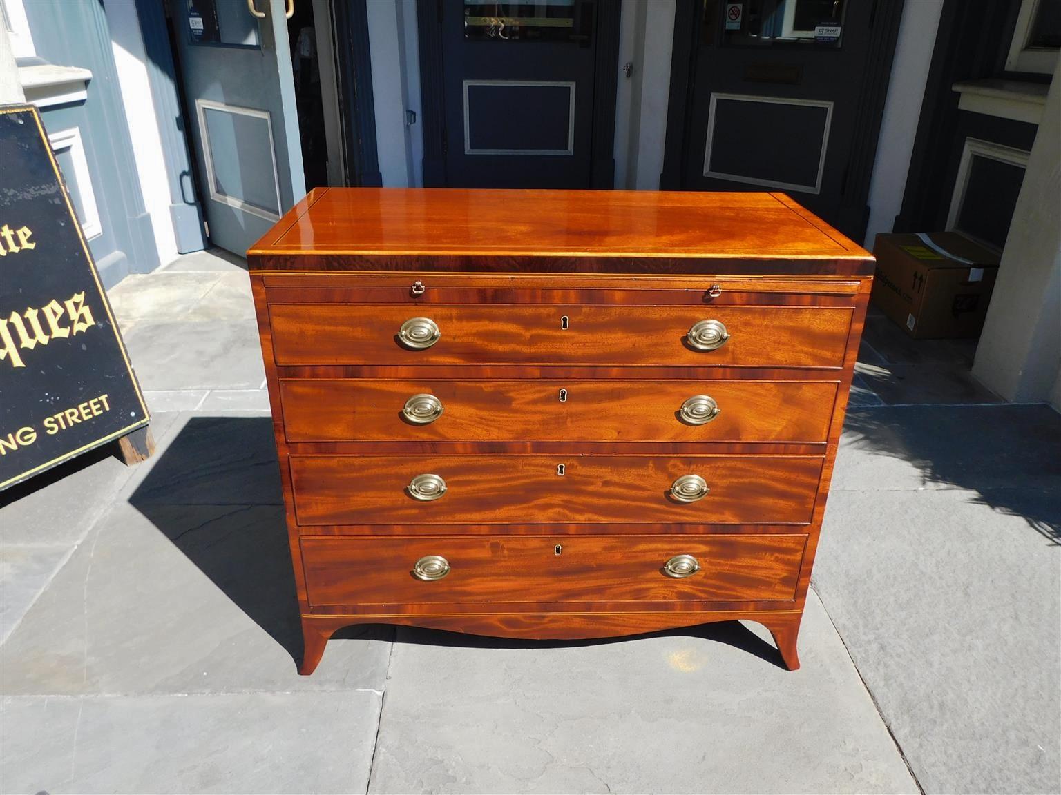 Scottish Hepplewhite mahogany four graduated chest of drawers with a upper brushing slide, satinwood and ebony string inlays, cross banding, original period oval brasses, lower flanking carved scalloped skirts, and resting on the original splayed