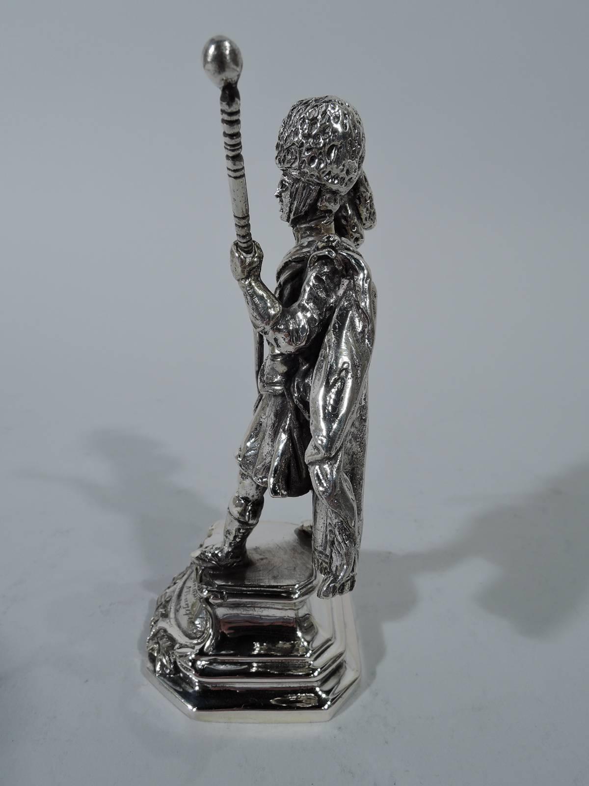 Cast military figurine of Scottish Highlander in full stride. He wears kilt, cape, and bearskin hat, and holds a staff. Plinth mount with script inscription and 1745, the year of the Jacobite Rising lead by the Young Pretender. A great gift for