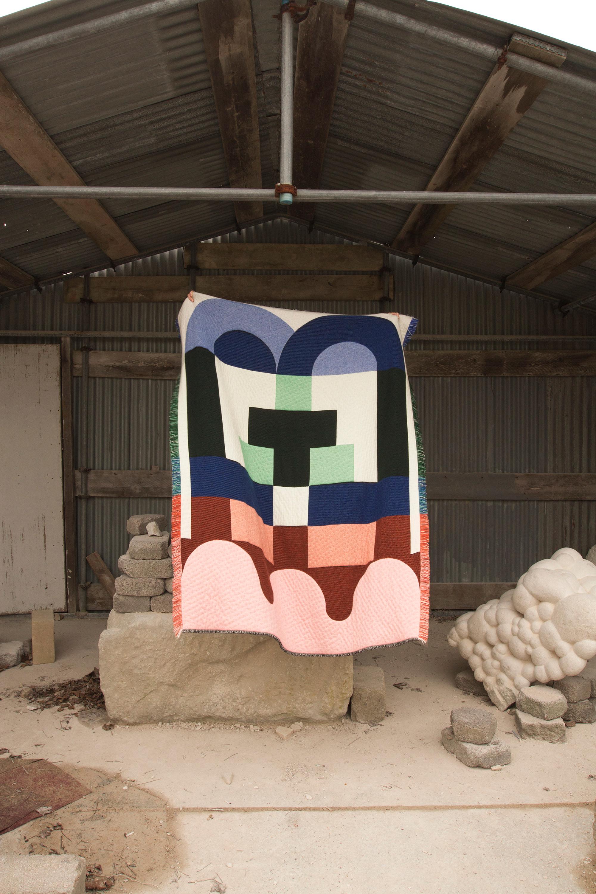'Brutalist' double sided blanket woven from cashmere + lambswool in blue, pink + white by Granite + Smoke.

Our cashmere & lambswool blankets are made by expert craftsmen in a historical weaving mill dating back to 1866 in Scotland. Woven on