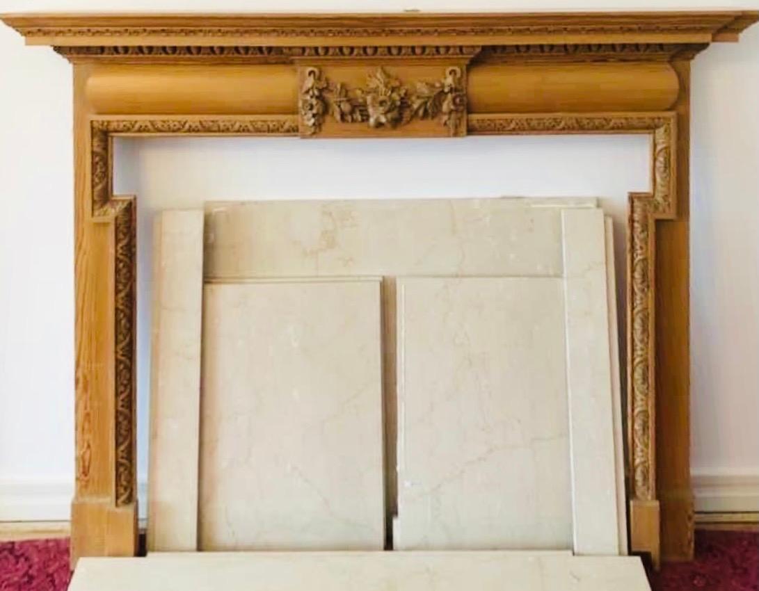 A fairly large late Victorian solid clear Scots pine fireplace surround showing great detailed carving and colour. A stepped corniced top shelf, with secondary under shelf rests above a central protruding tablet with a high relief floral festoon