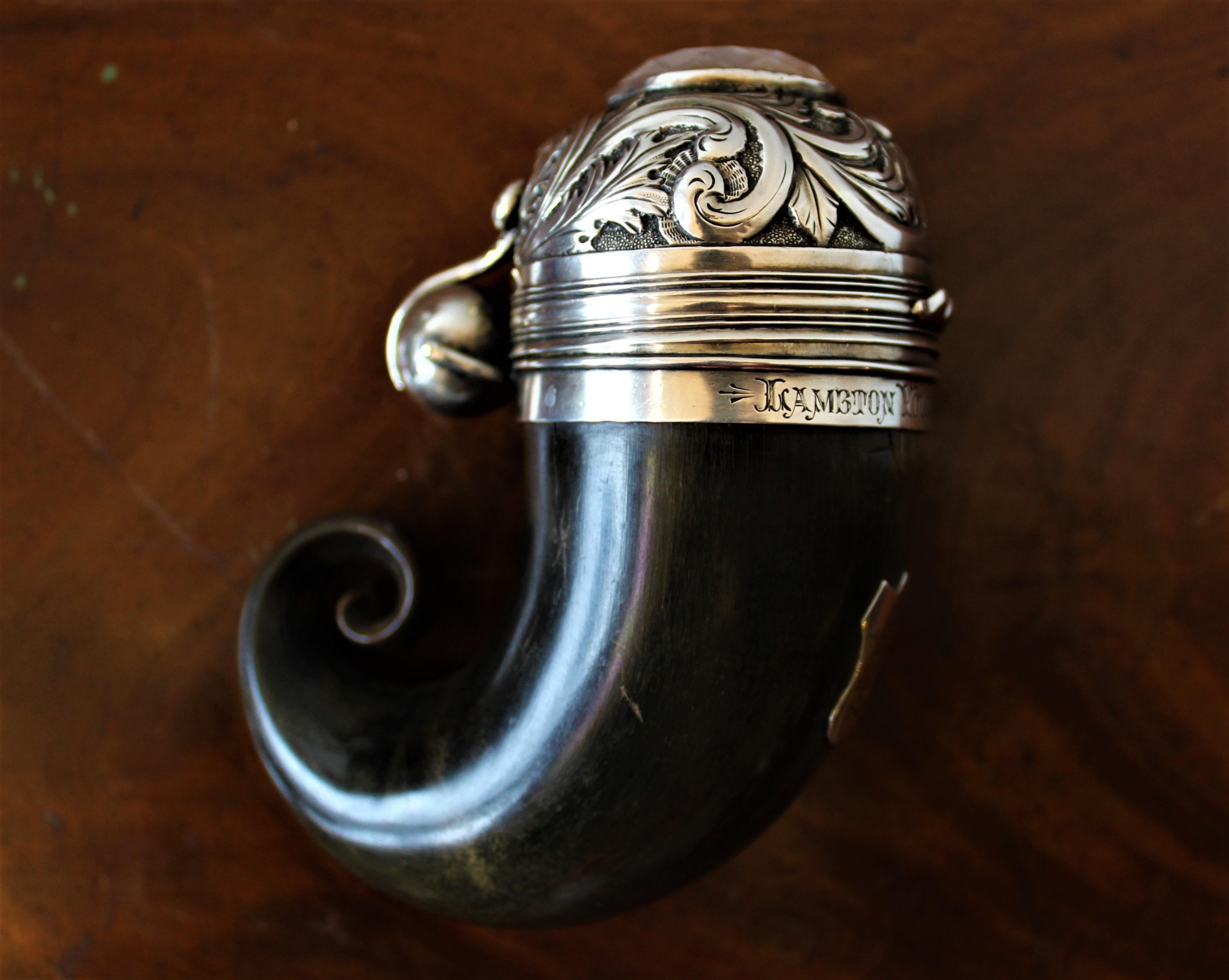 Dating from the early 19th century, this Scottish polished Horn and sterling silver mounted snuff mull is heavily engraved. Inlaid on the top is a large cabachon cut citrine stone. The mull is marked 