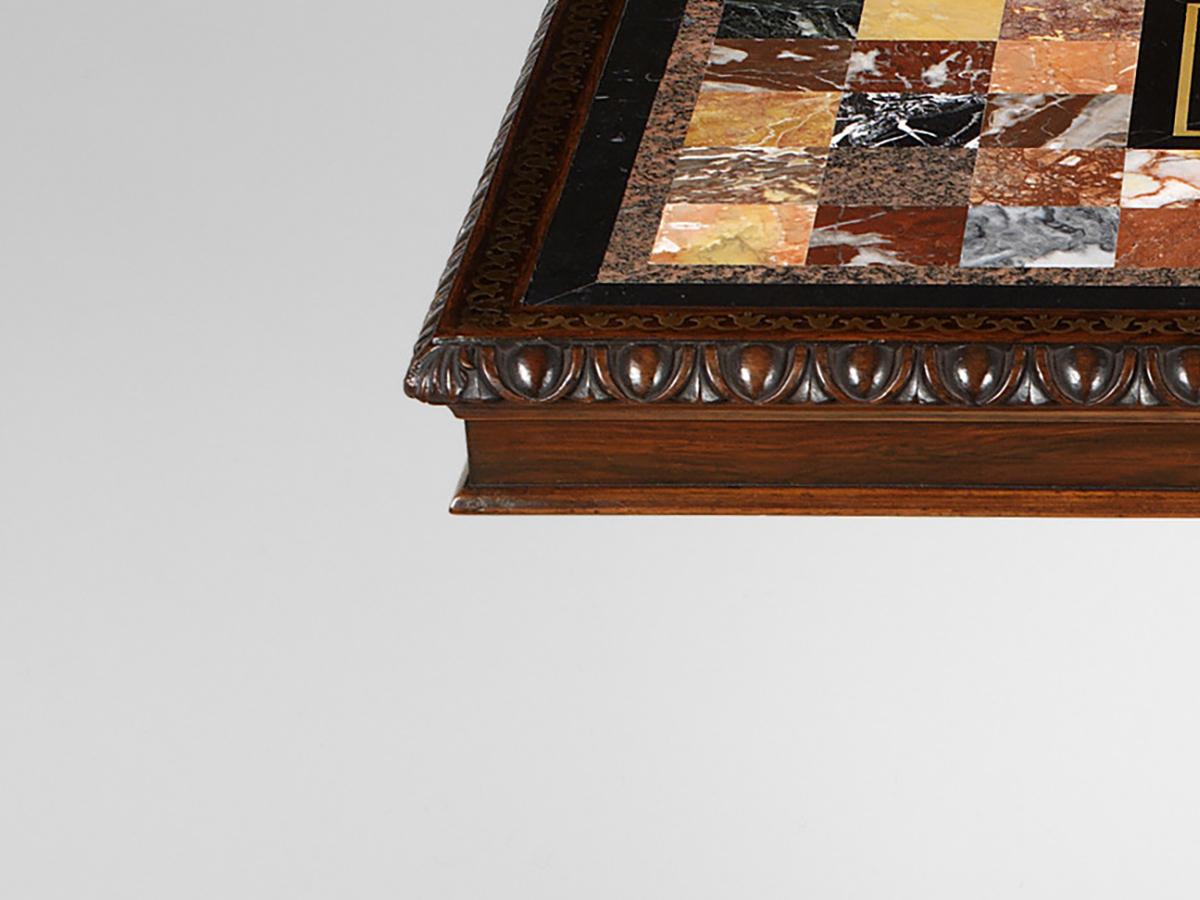 The rectangular top inset with various square marbles including sienna, Sarrancolin, Brocatello, Portoro and others and centred by a panel depicting a parrot perched on a branch, the edge with egg and dart moulding; on a tapering fluted and